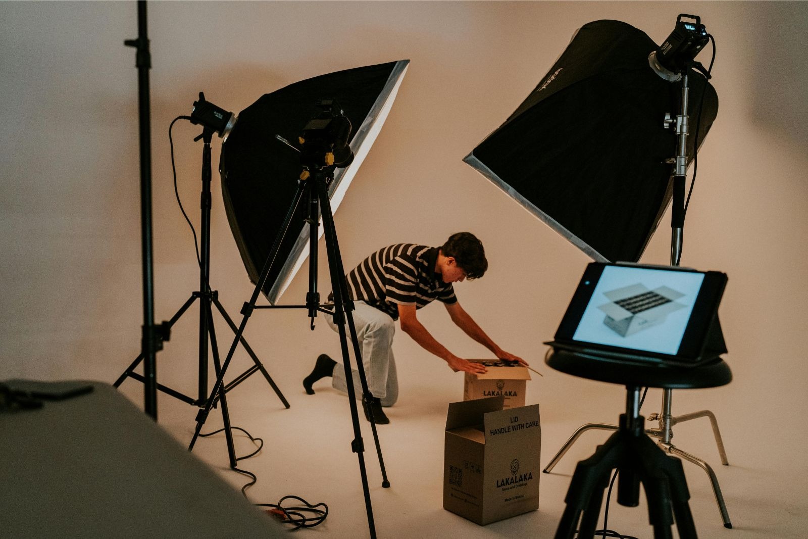 Professional business product photoshoot setup in a fully equipped studio with advanced lighting.