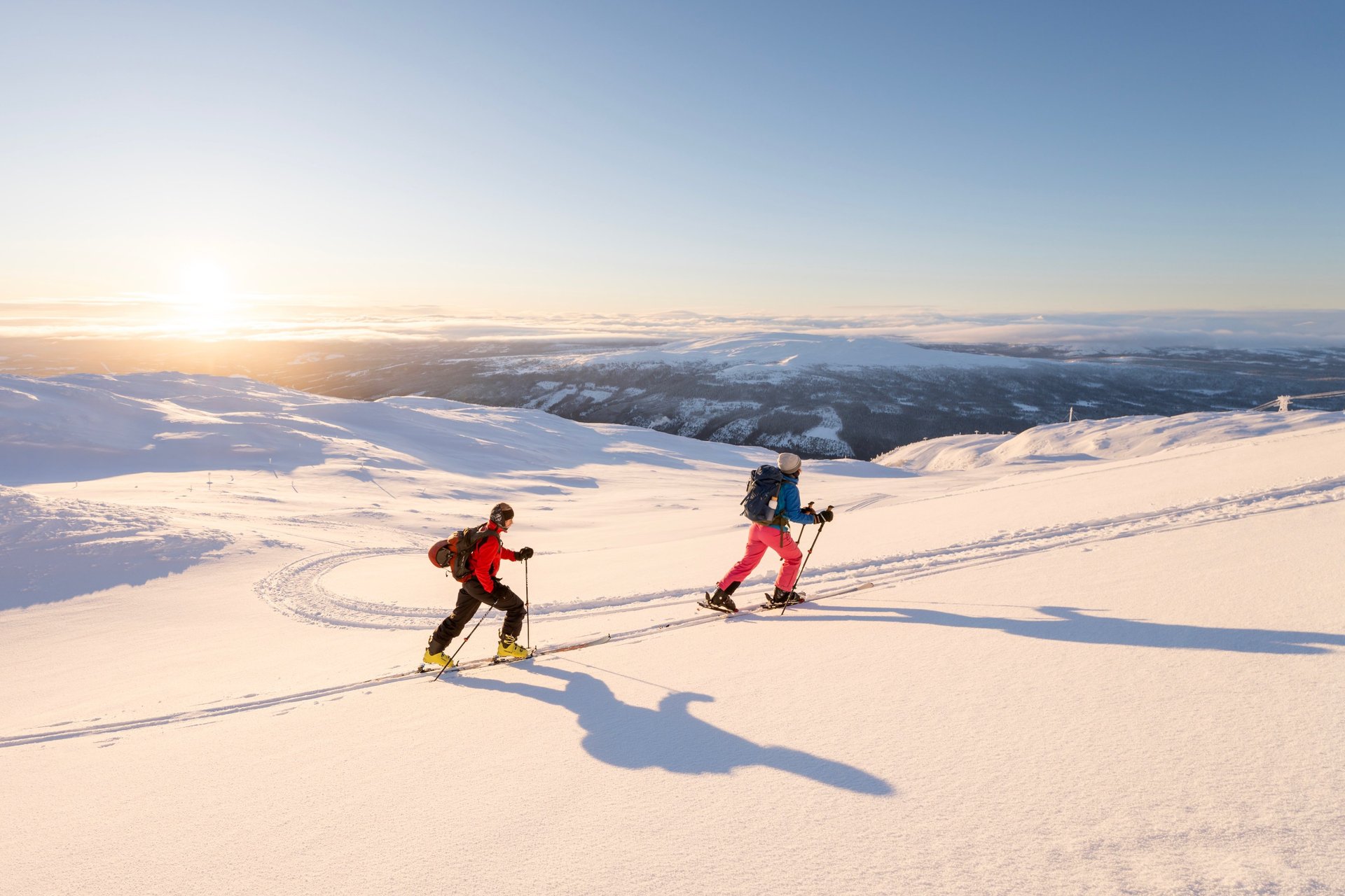 two people ski touring in the snow