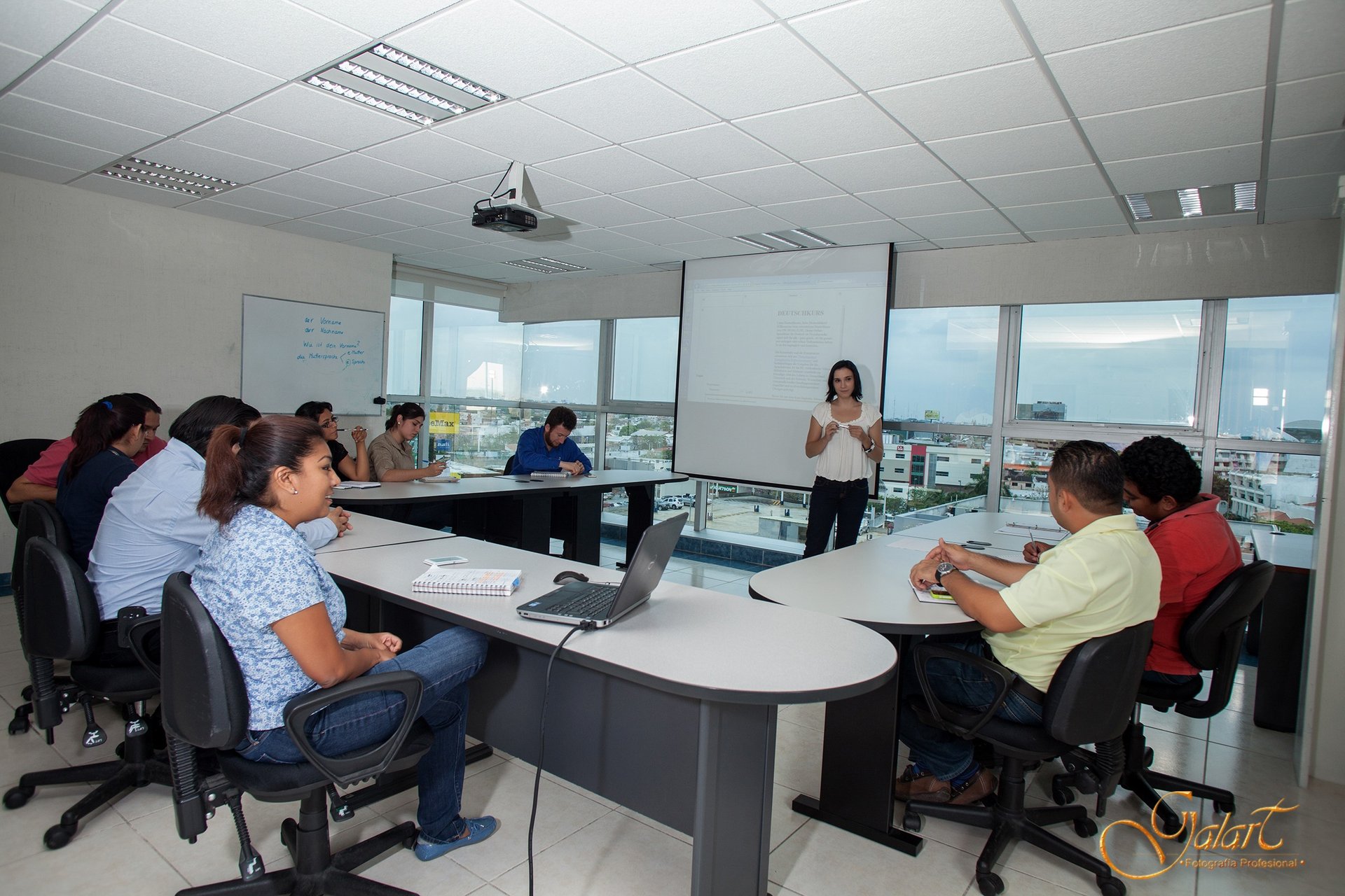 a woman in a conference room with a man in a white shirt