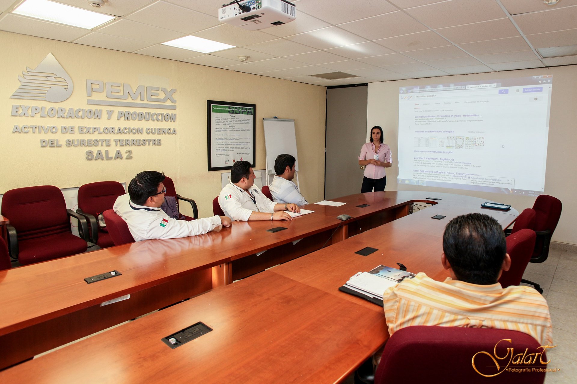 a group of people sitting at a table with a presentation