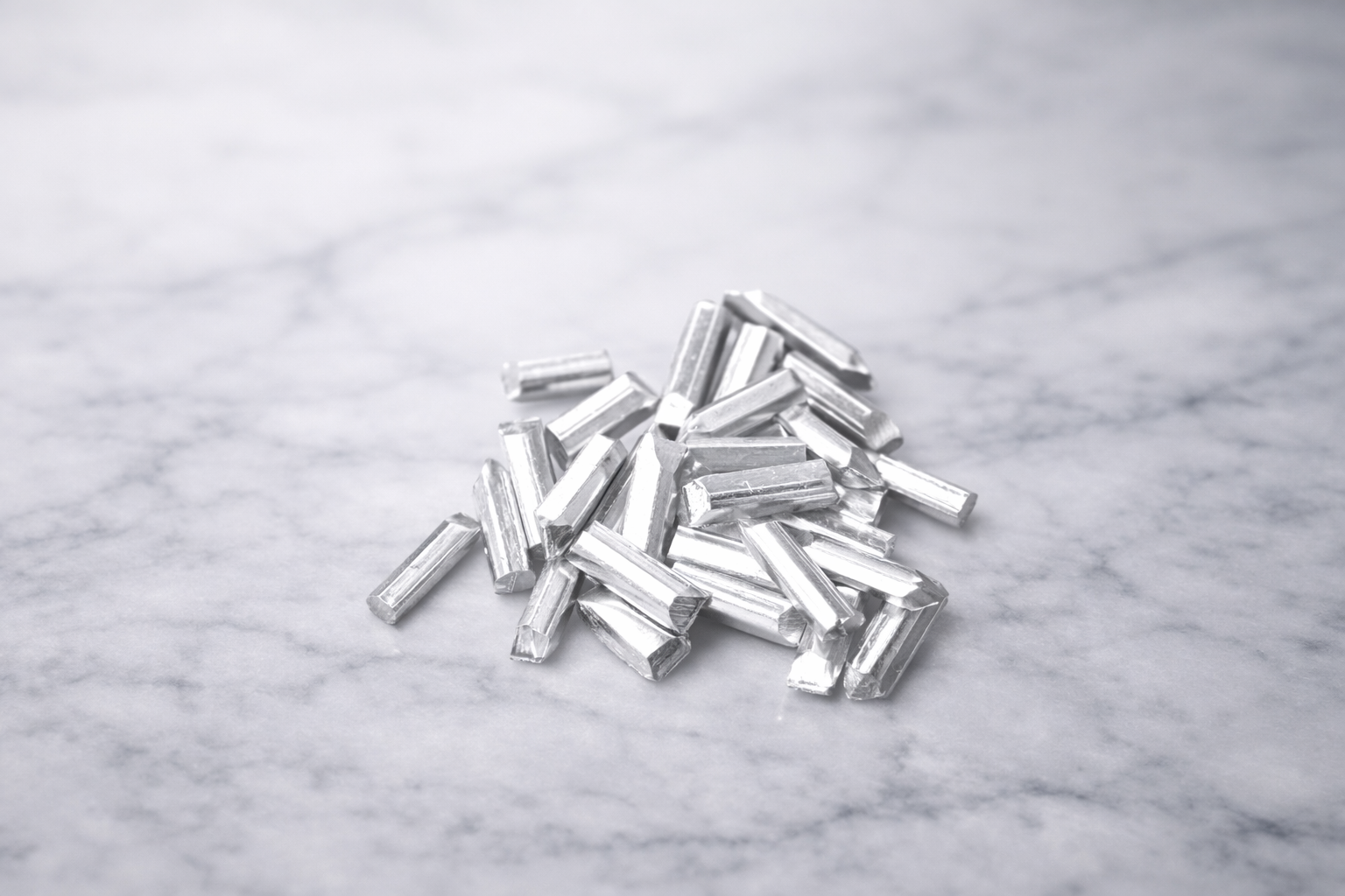Pure silver DIY components laid out on marble for jewelry making and crafting