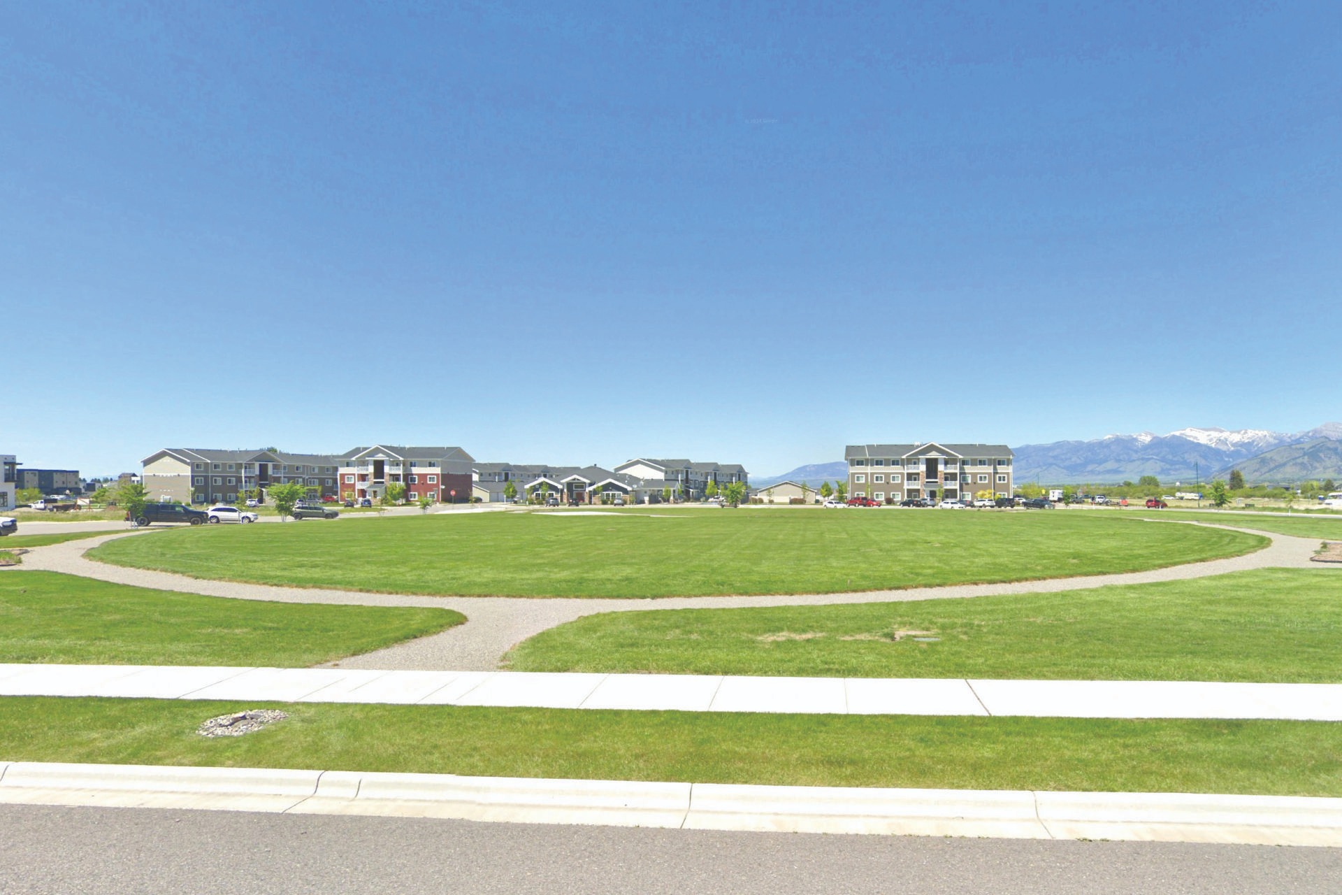 a park with a circular shaped lawn and a circular shaped lawn