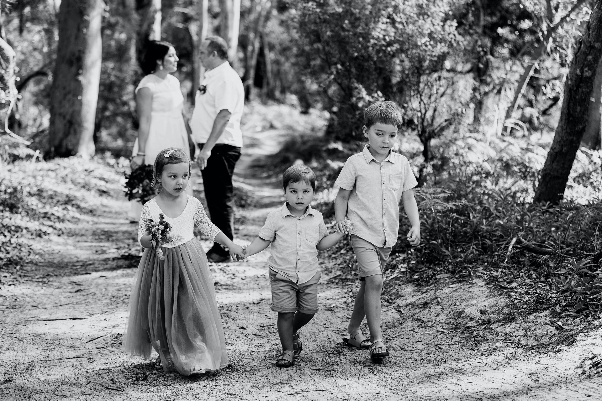 Children participating in a joyful Noosa Sunshine Coast Briabane wedding ceremony Noosa beach 