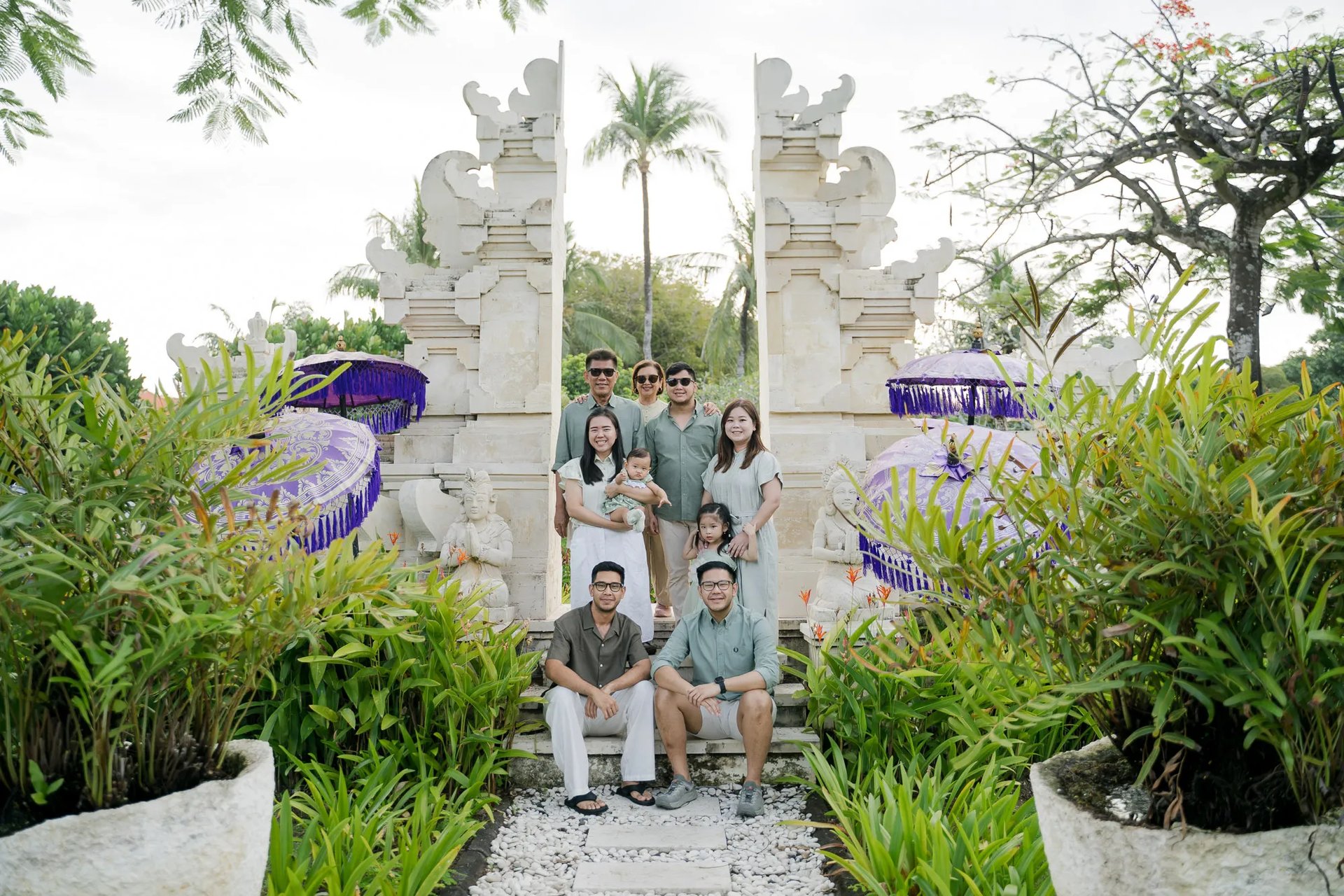 Multigenerational family portrait at a traditional Balinese gate during a family photography session in Nusa Dua Bali.