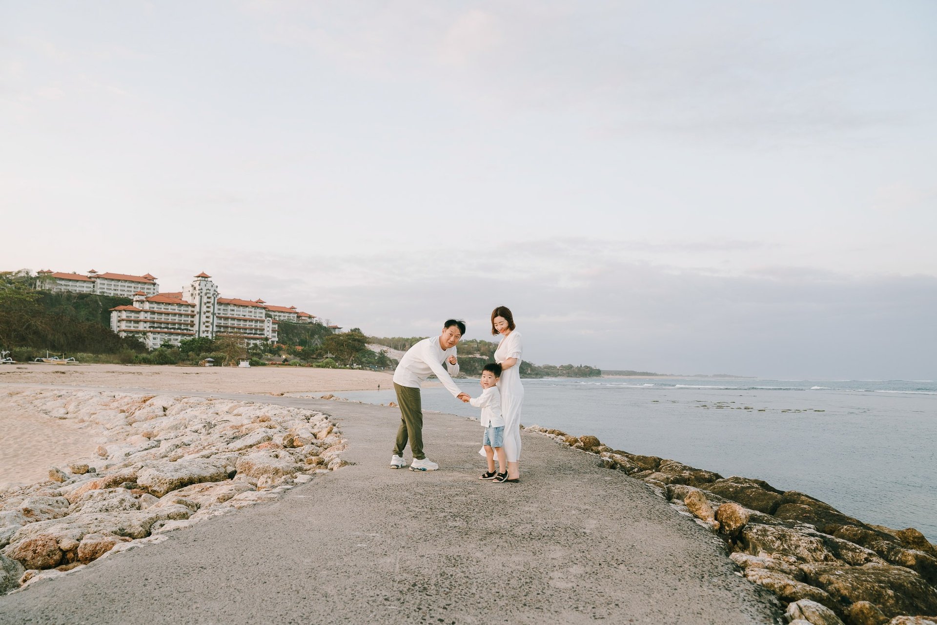 Father and son portrait on the jetty at The Apurva Kempinski Bali beachfront.