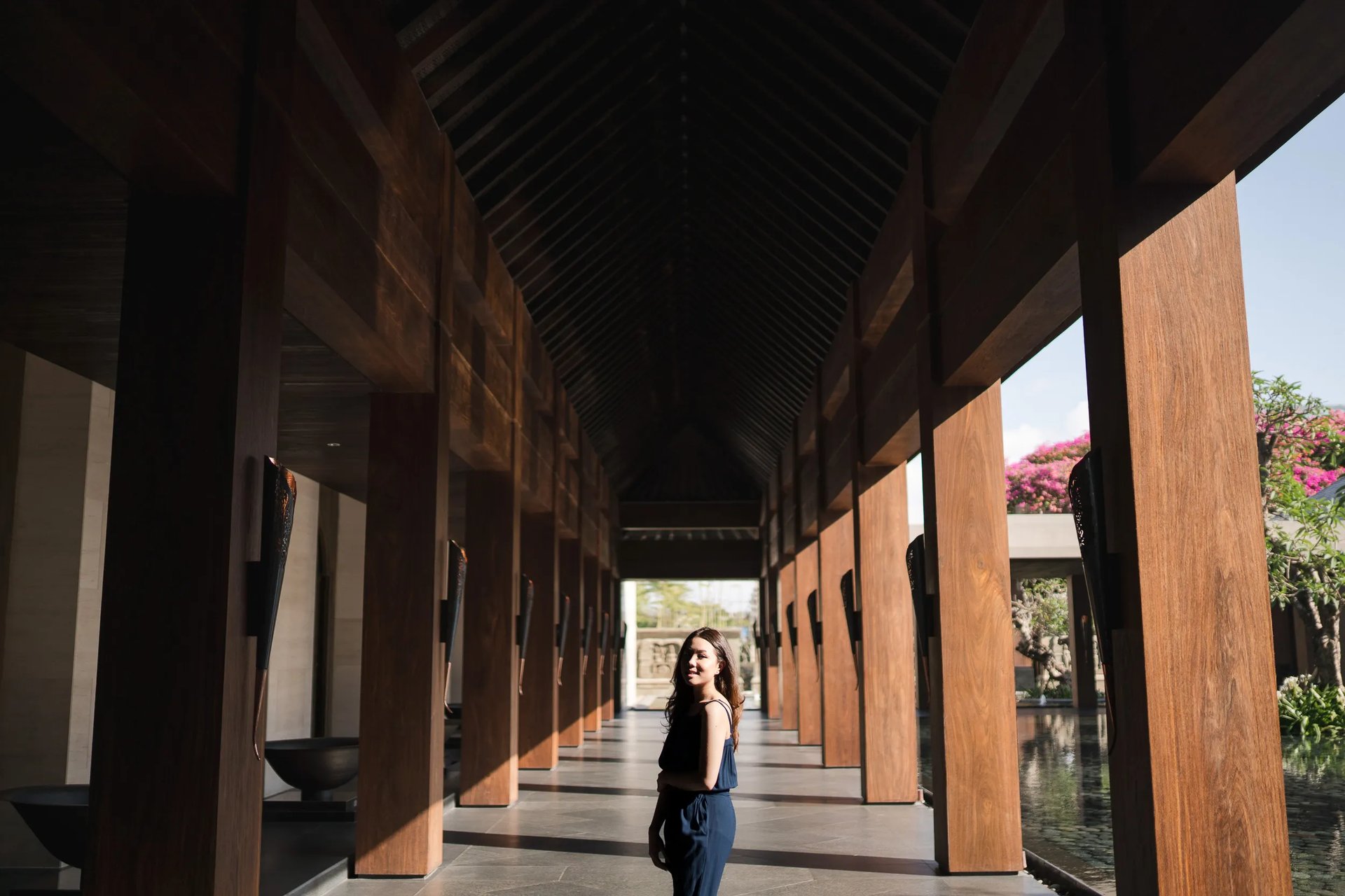 woman walking through kempinski bali corridor nusa dua