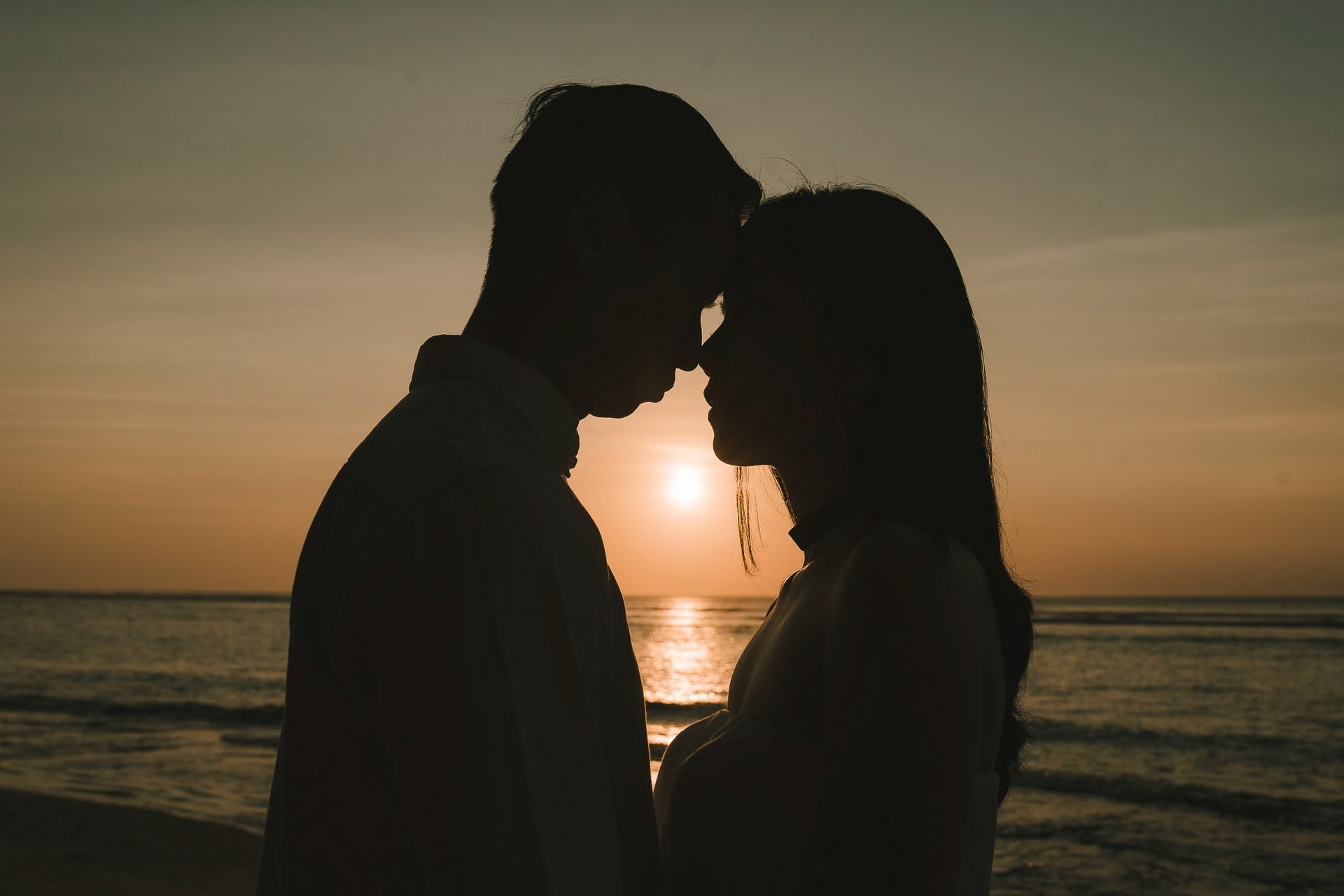 Silhouette couple during a sunset proposal photography session at Anantara Uluwatu Bali Resort.