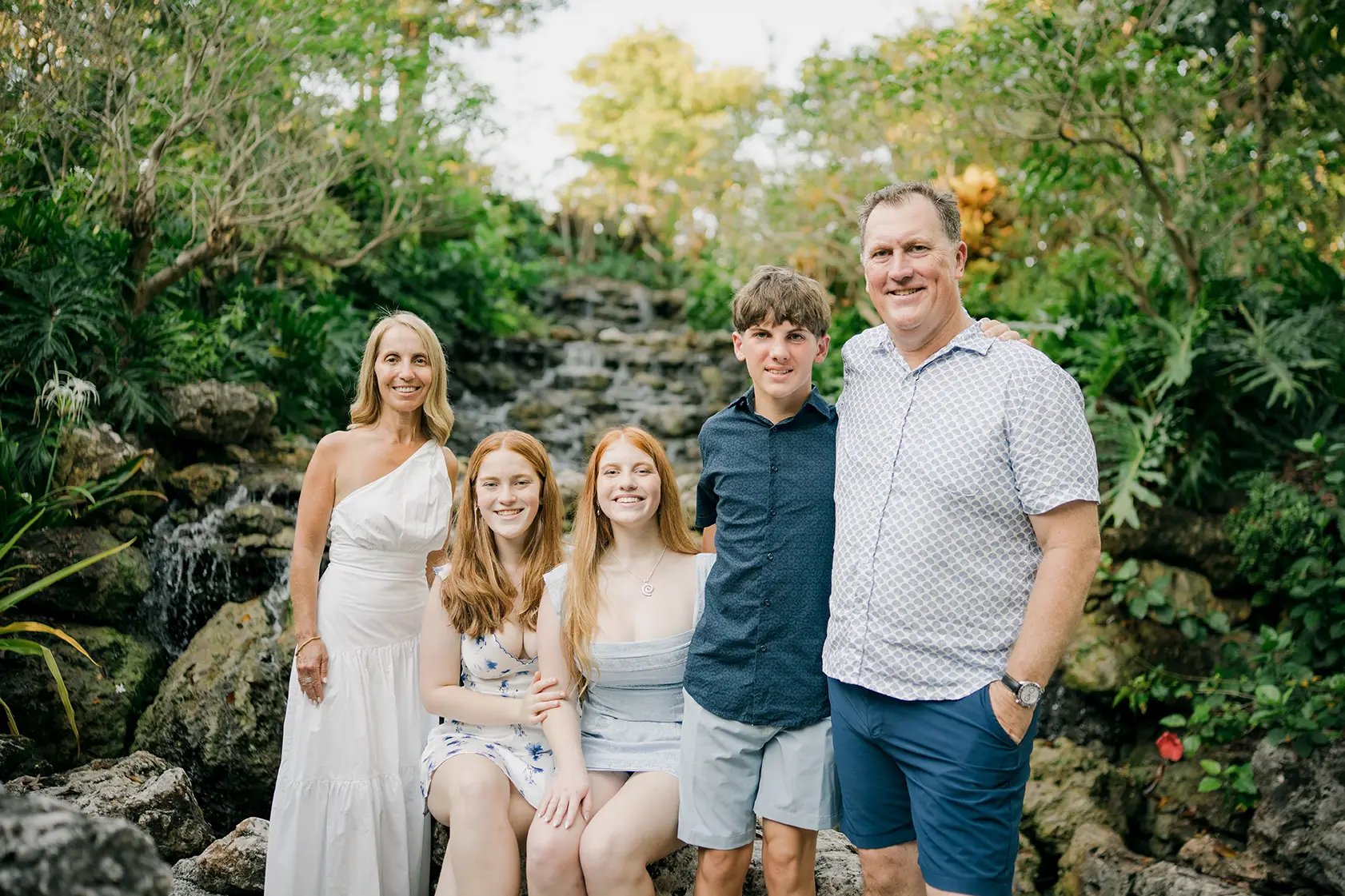 Family portrait surrounded by tropical gardens during a family photography session at AYANA Resort Bali