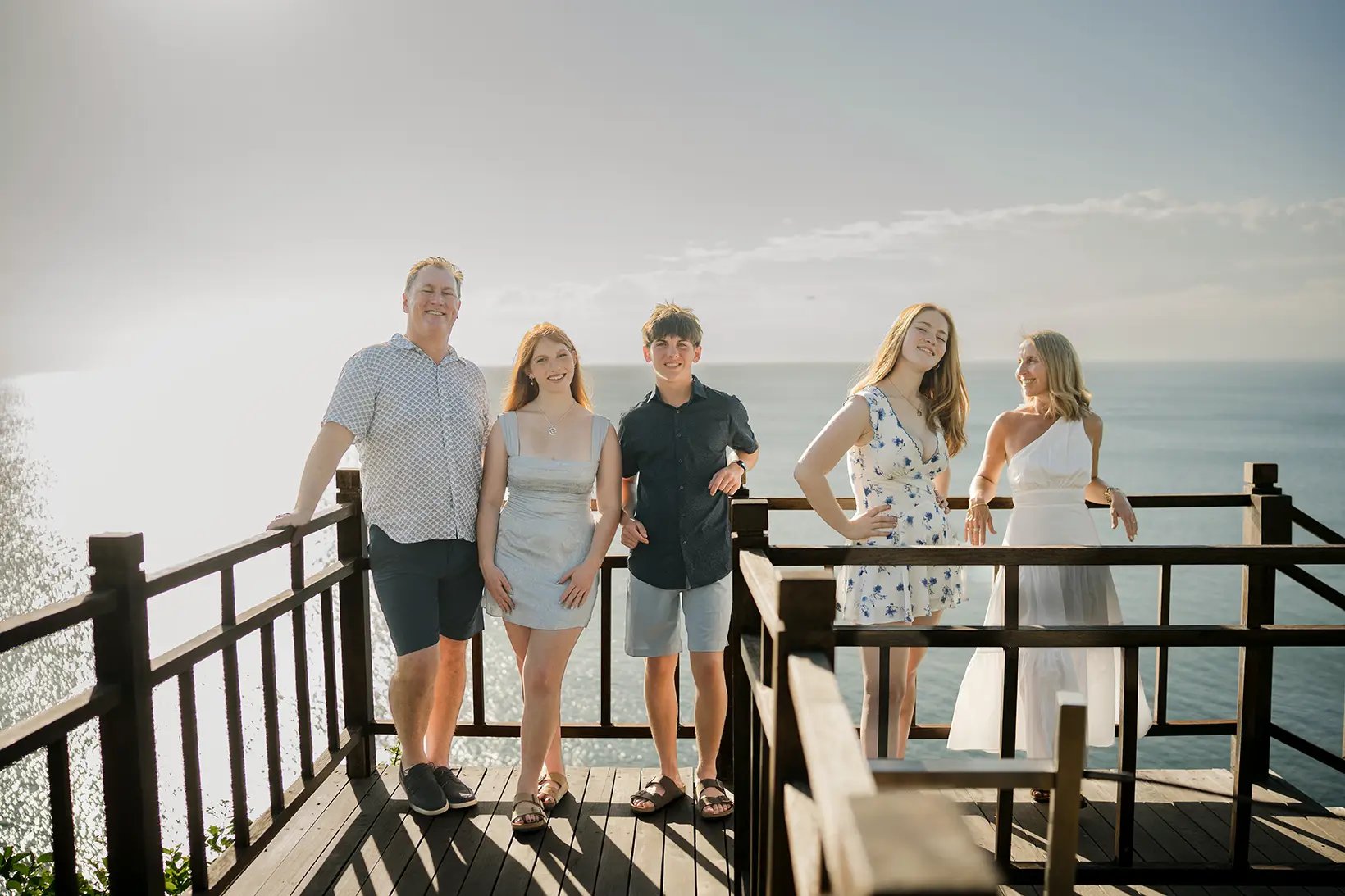 Family enjoying panoramic ocean views during a family photography session at AYANA Resort Bali