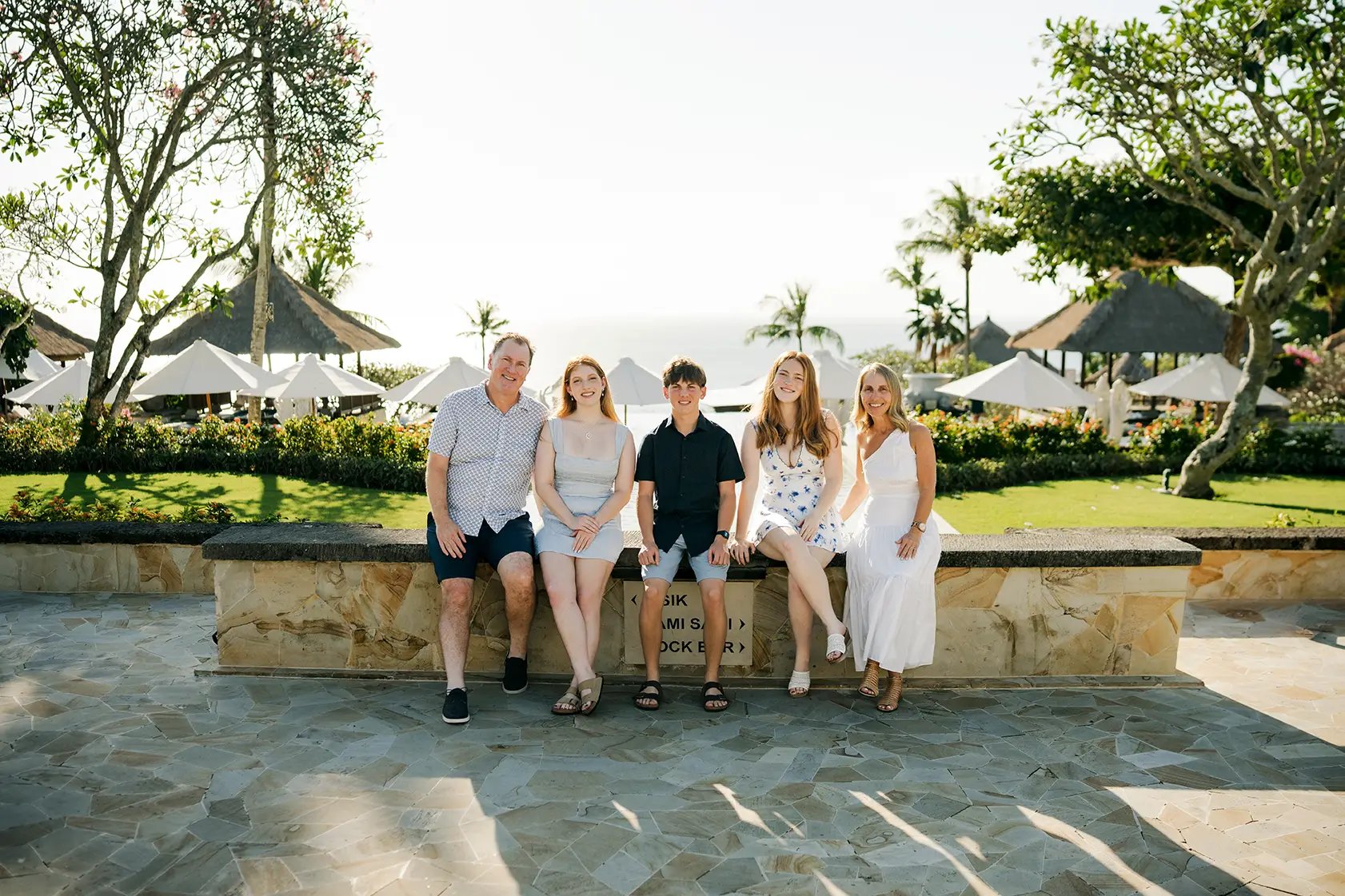 Family portrait surrounded by tropical gardens during a family photography session at AYANA Resort Bali