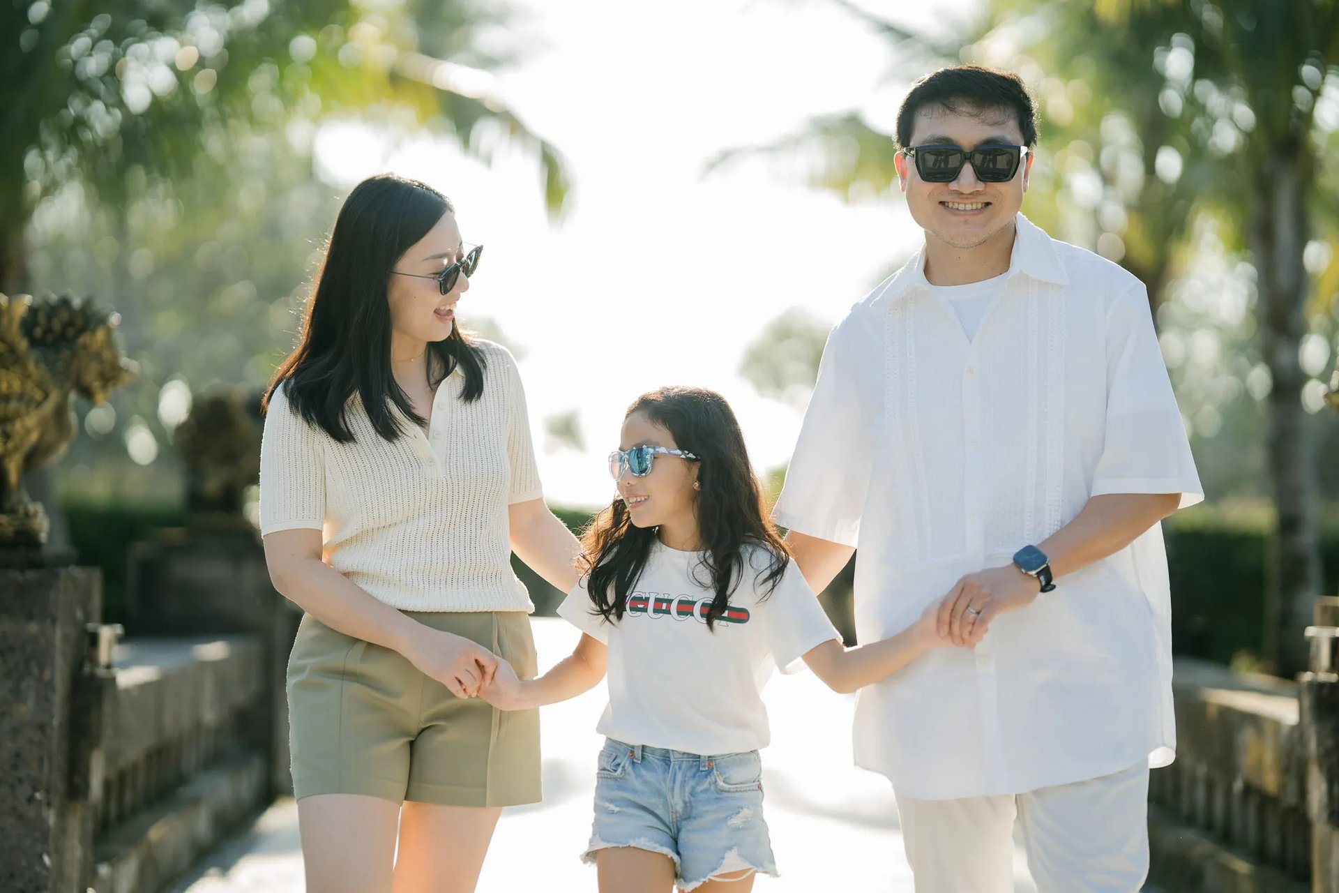 Family walking together through the tropical gardens of InterContinental Bali Resort