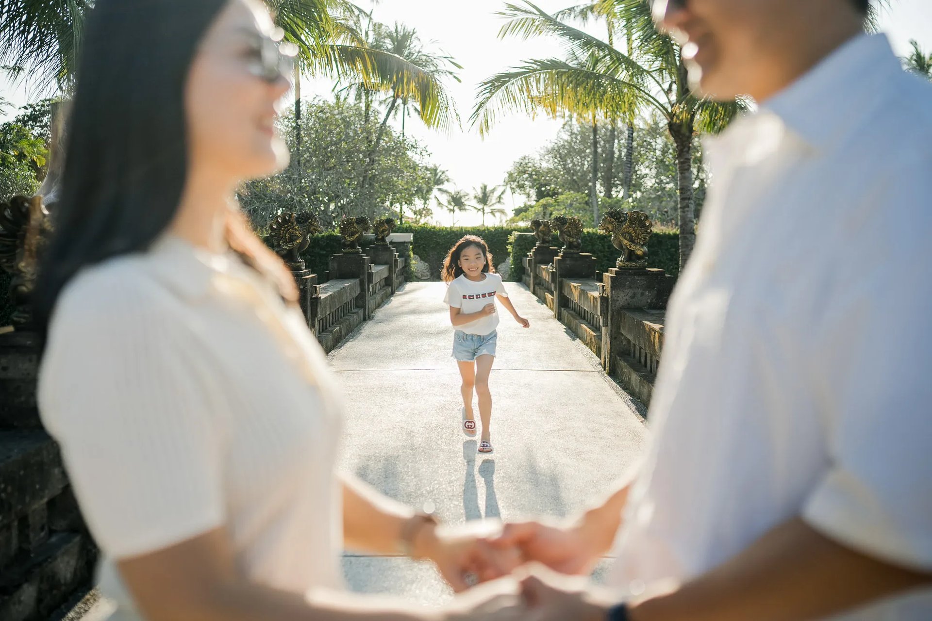 Family holding hands during a sunset photography session at InterContinental Bali Resort