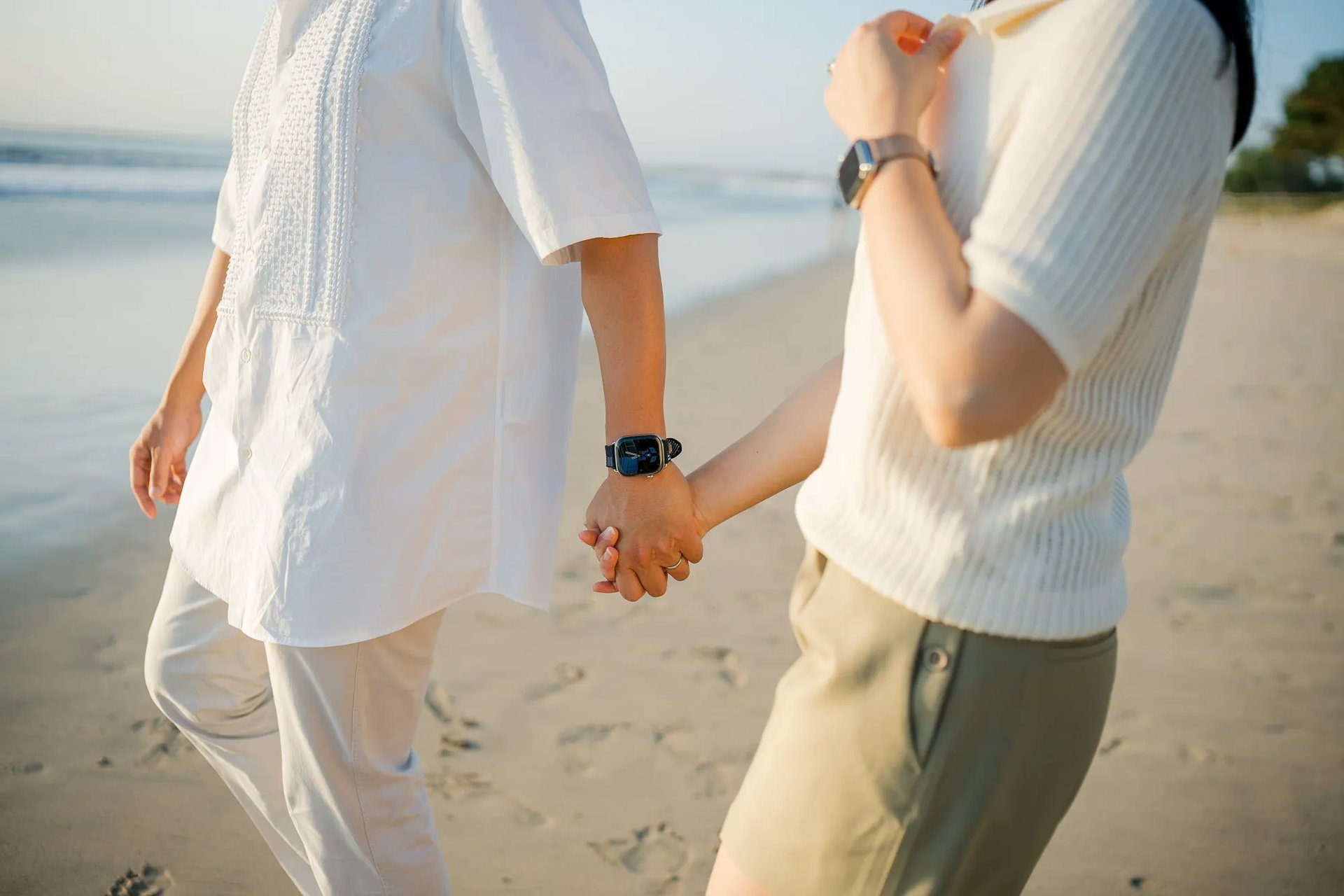 Close-up of parents holding hands during a family photography session at InterContinental Bali Resort