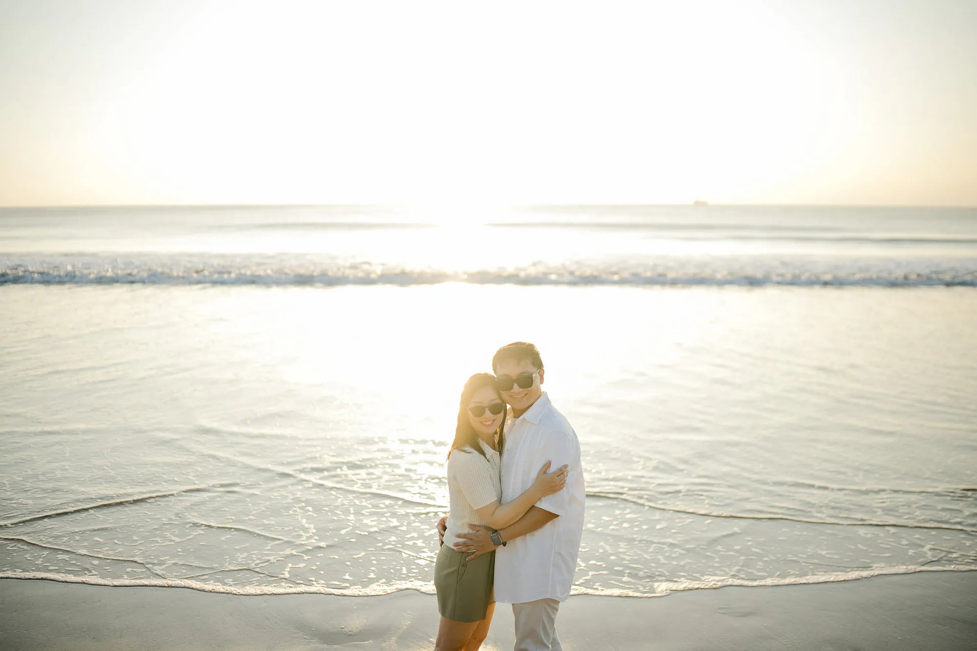 Family embracing during a sunset photography session at InterContinental Bali Resort beach