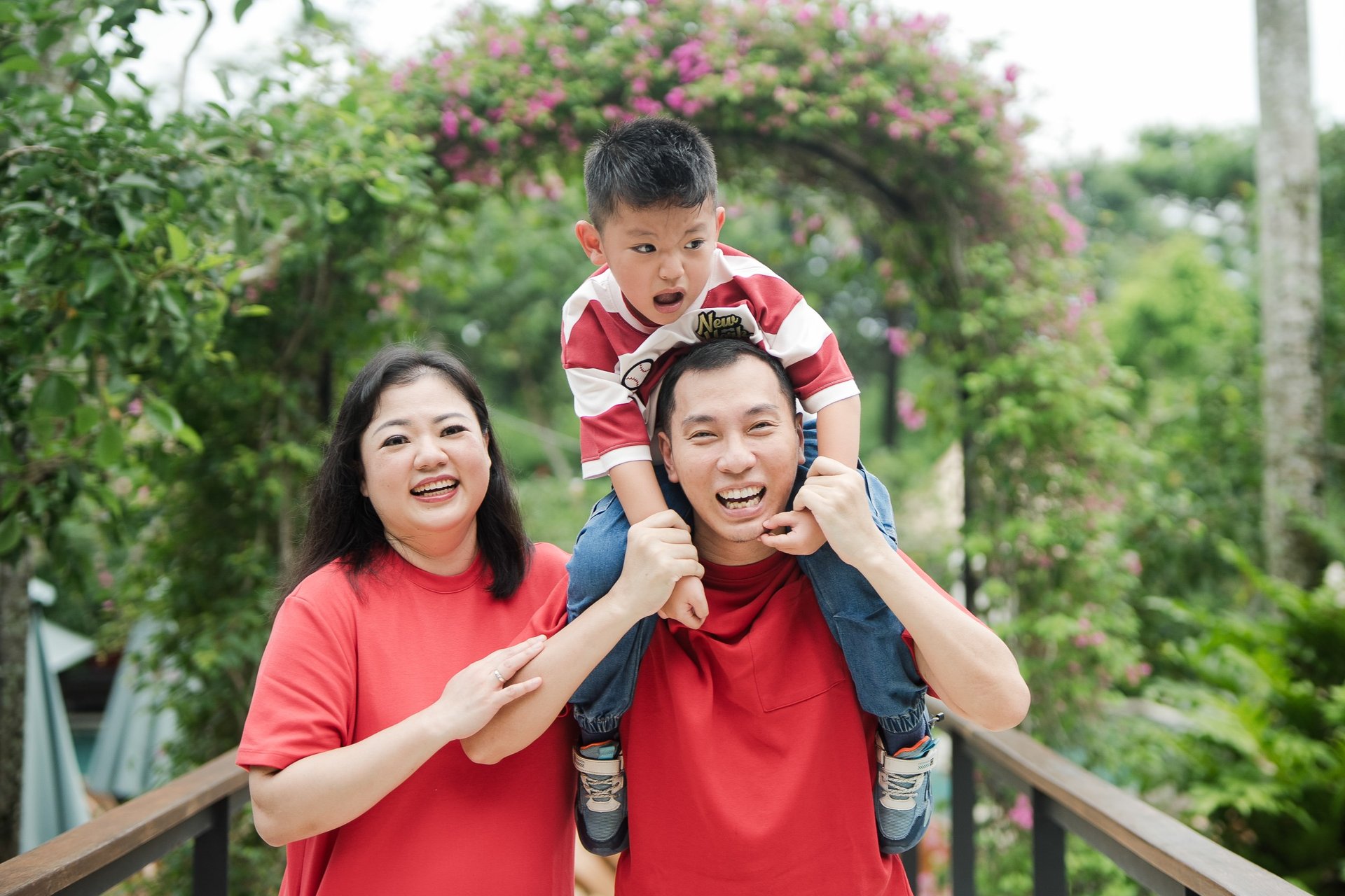 father carrying child on shoulders during a relaxed family photography session at Movenpick Jimbaran Bali