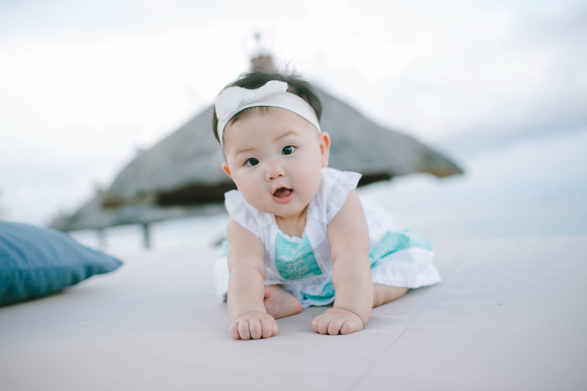 Baby crawling on daybed during family photography session at Sofitel Nusa Dua Bali