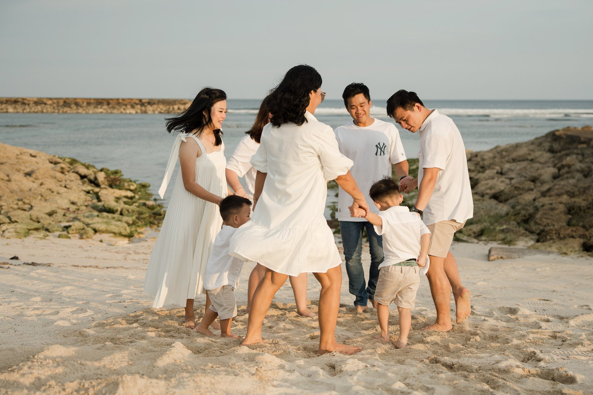 Family walking together along the beach near The Apurva Kempinski Nusa Dua Bali