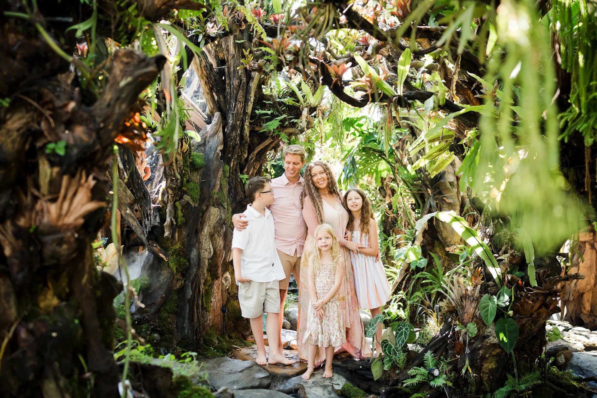 Family walking through the lush garden pathway at Umbul Sari Water Garden in Ubud Bali