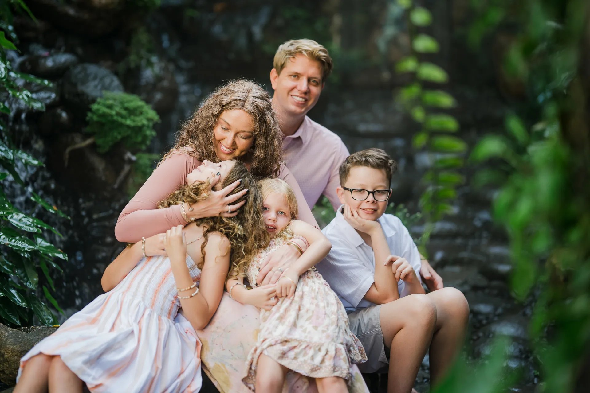 Relaxed family portrait surrounded by tropical greenery in Ubud Bali
