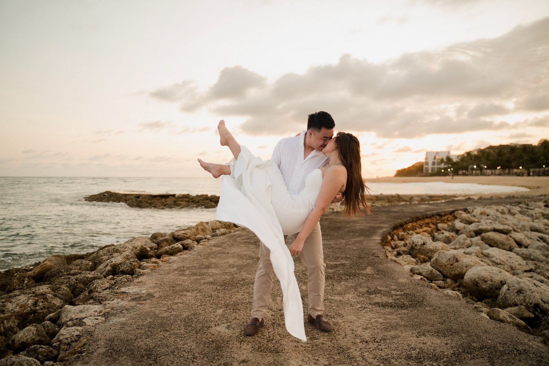 Couple embracing during golden sunset beach prewedding photoshoot at Apurva Kempinski Bali