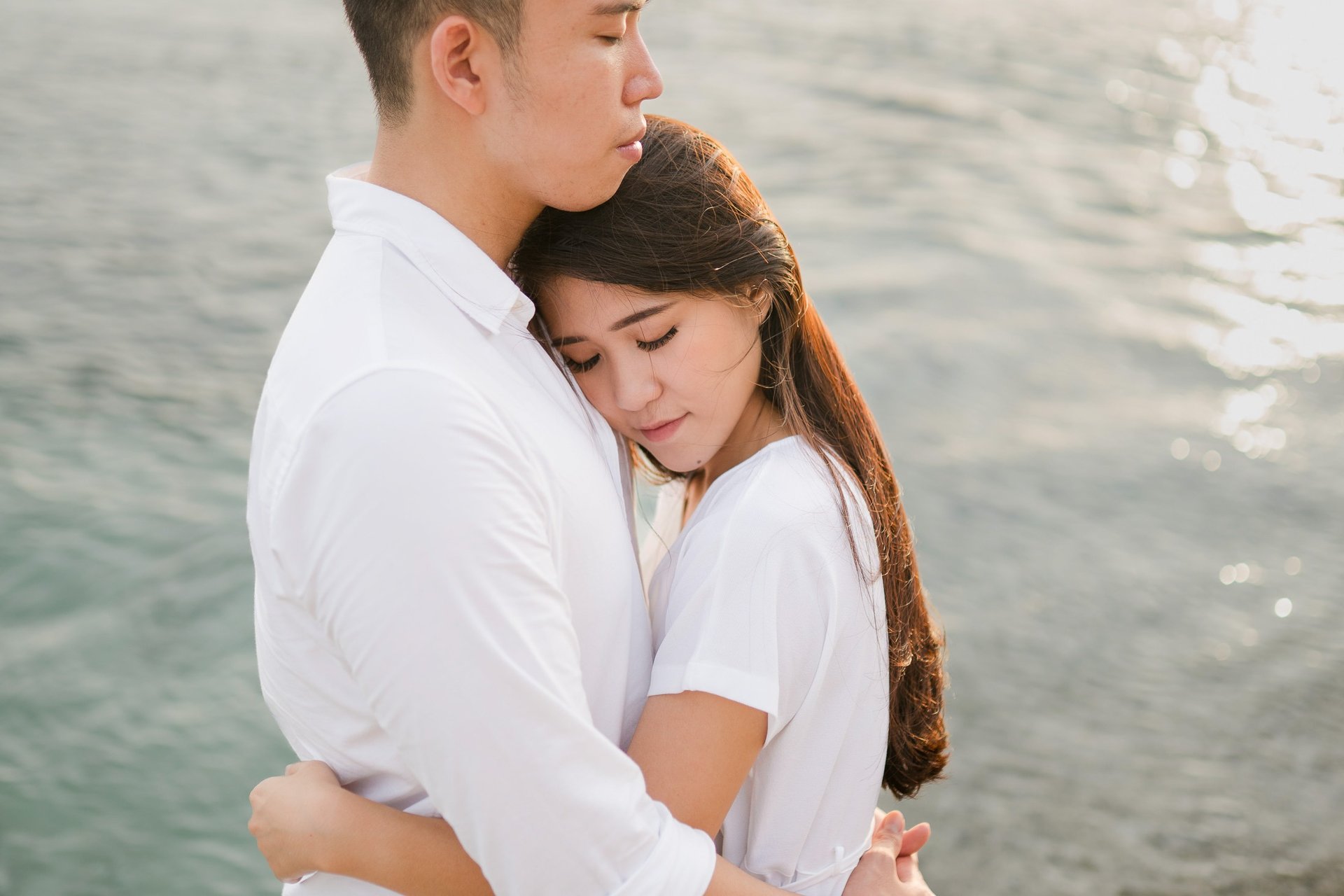 Intimate couple proposal moment by the ocean at Melasti Beach Bali