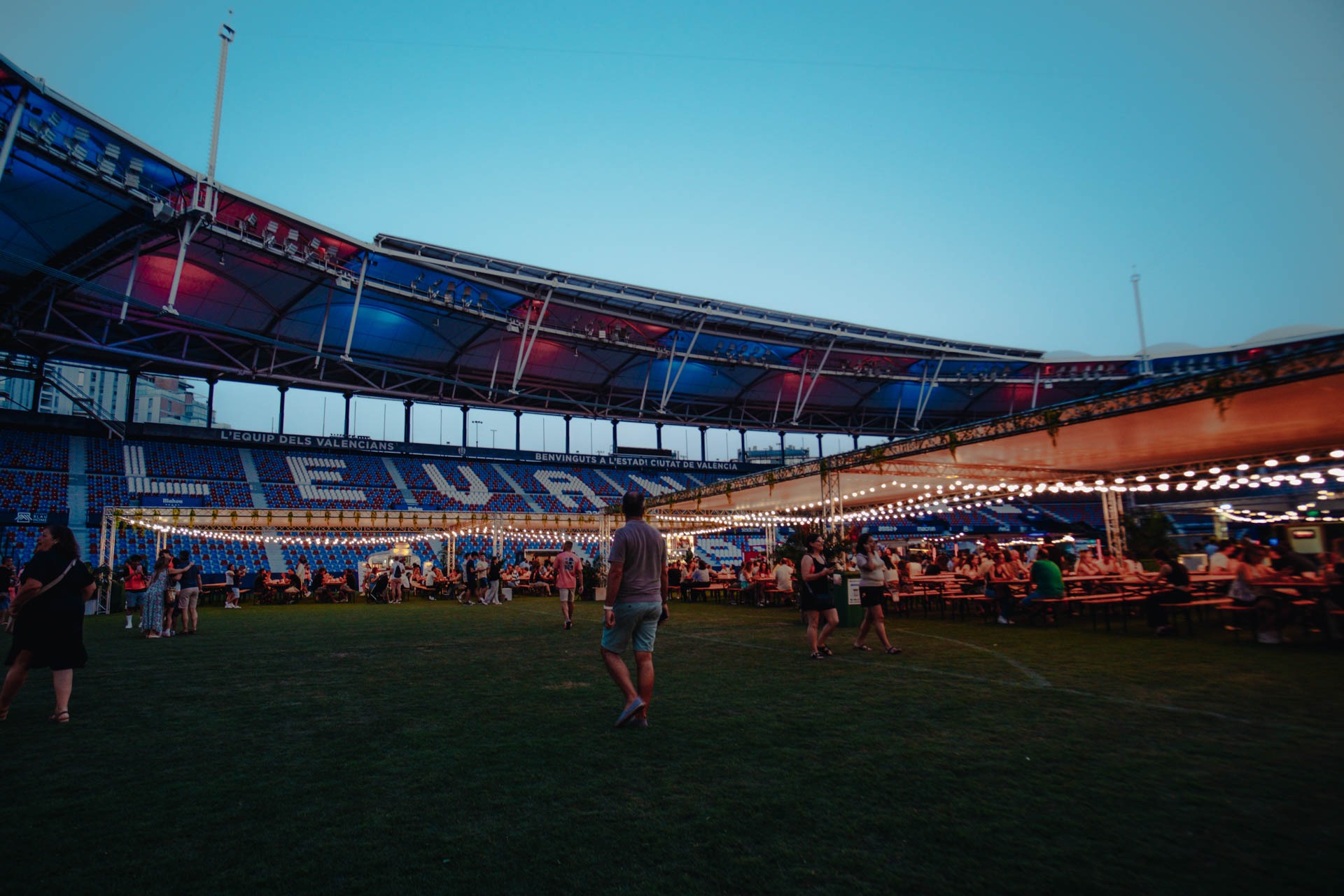 a man standing in a field with a crowd of people