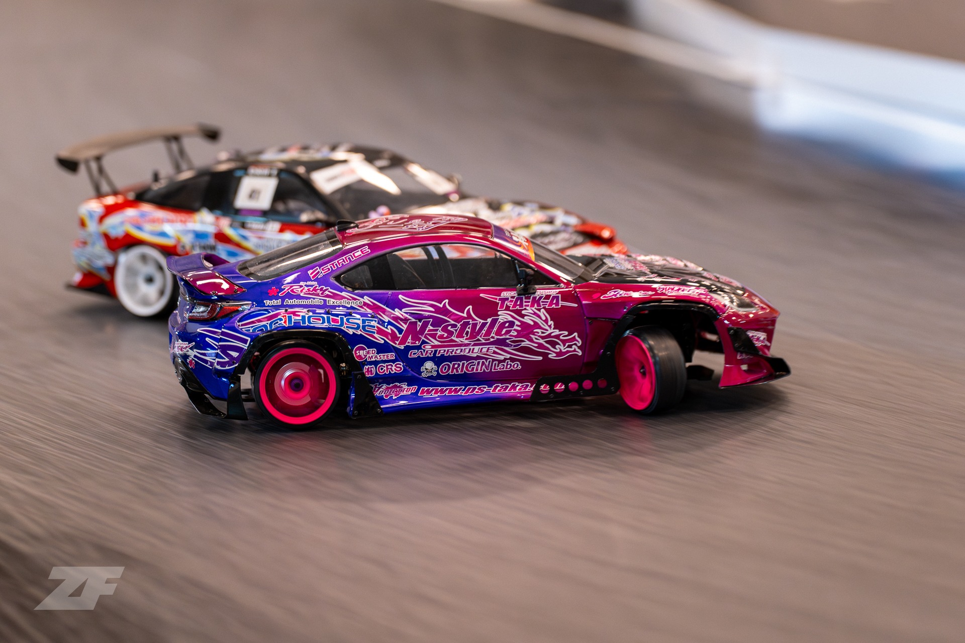 a pink and blue RC car drifting
