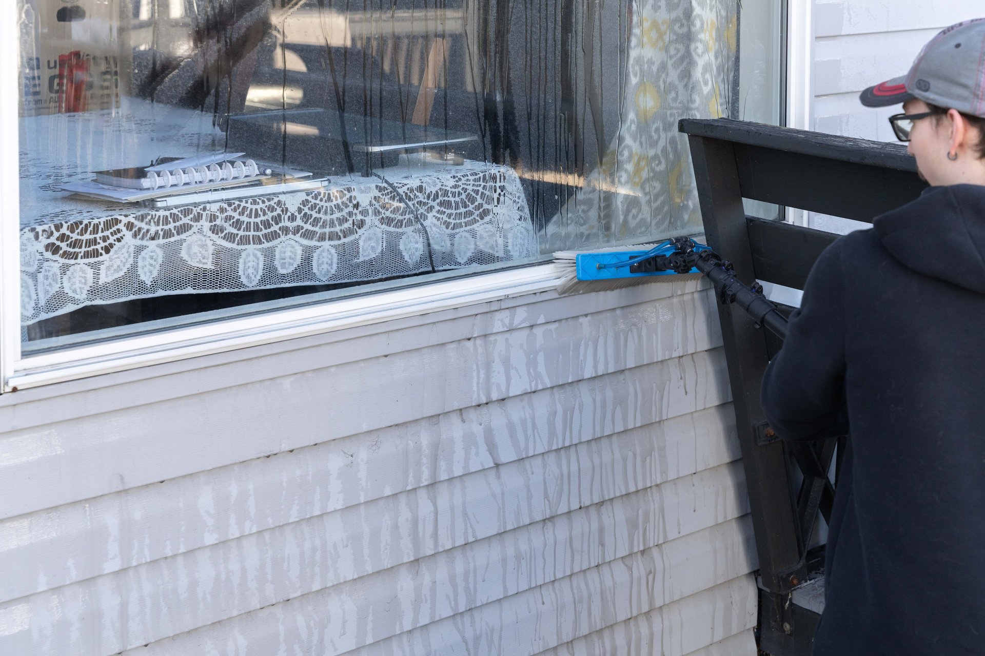 Man Cleaning Window Frame