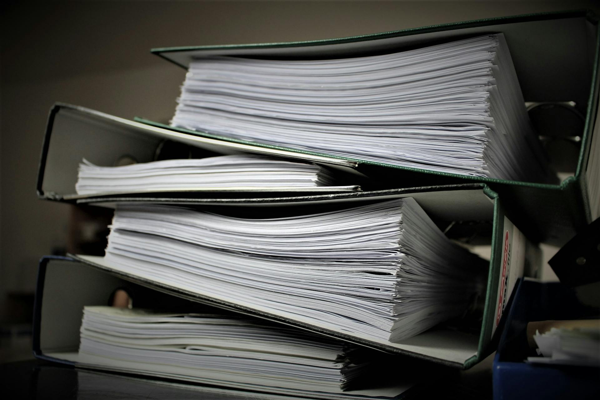 Stacked office files. Admin careers in brief