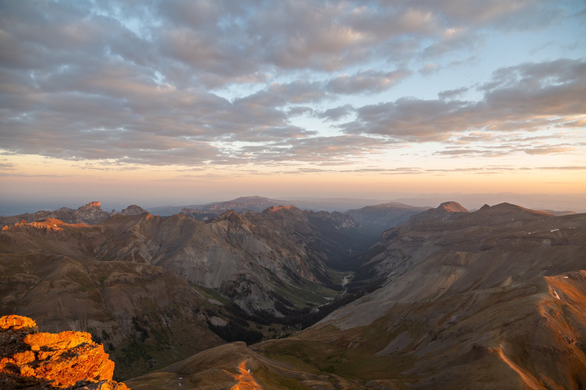 Sunrise from Uncompahgre Peak summit, view of San Juan Mountain peaks and valleys