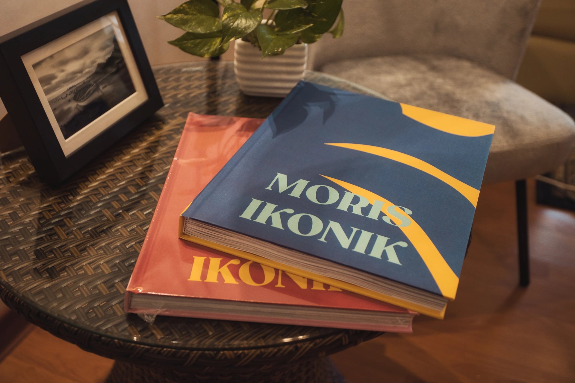 Moris Ikonik coffee table books on a rattan table in Mauritius