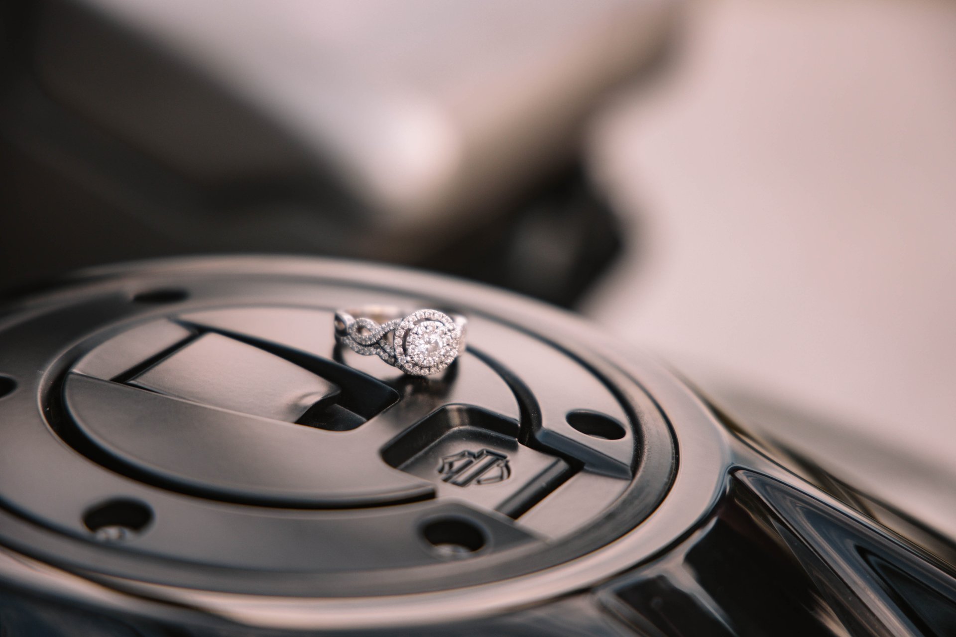 Engagement ring displayed with a Harley Davidson Symbol