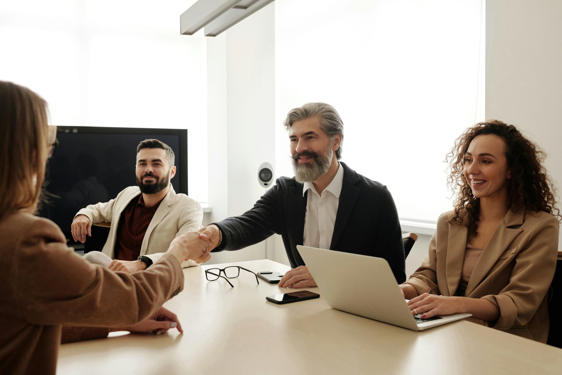 a man and woman shaking hands in a meeting room for mission