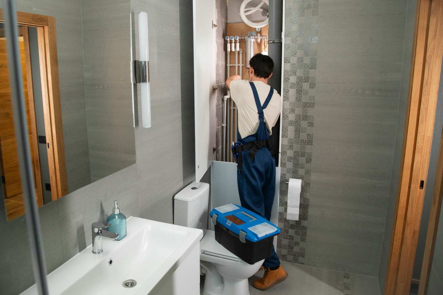 Licensed plumber installing a water heater in a Colorado Springs residential home