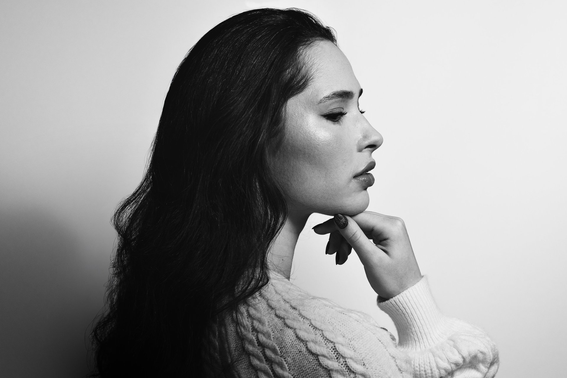 Black and white fine art profile portrait of a woman in a soft cinematic mood