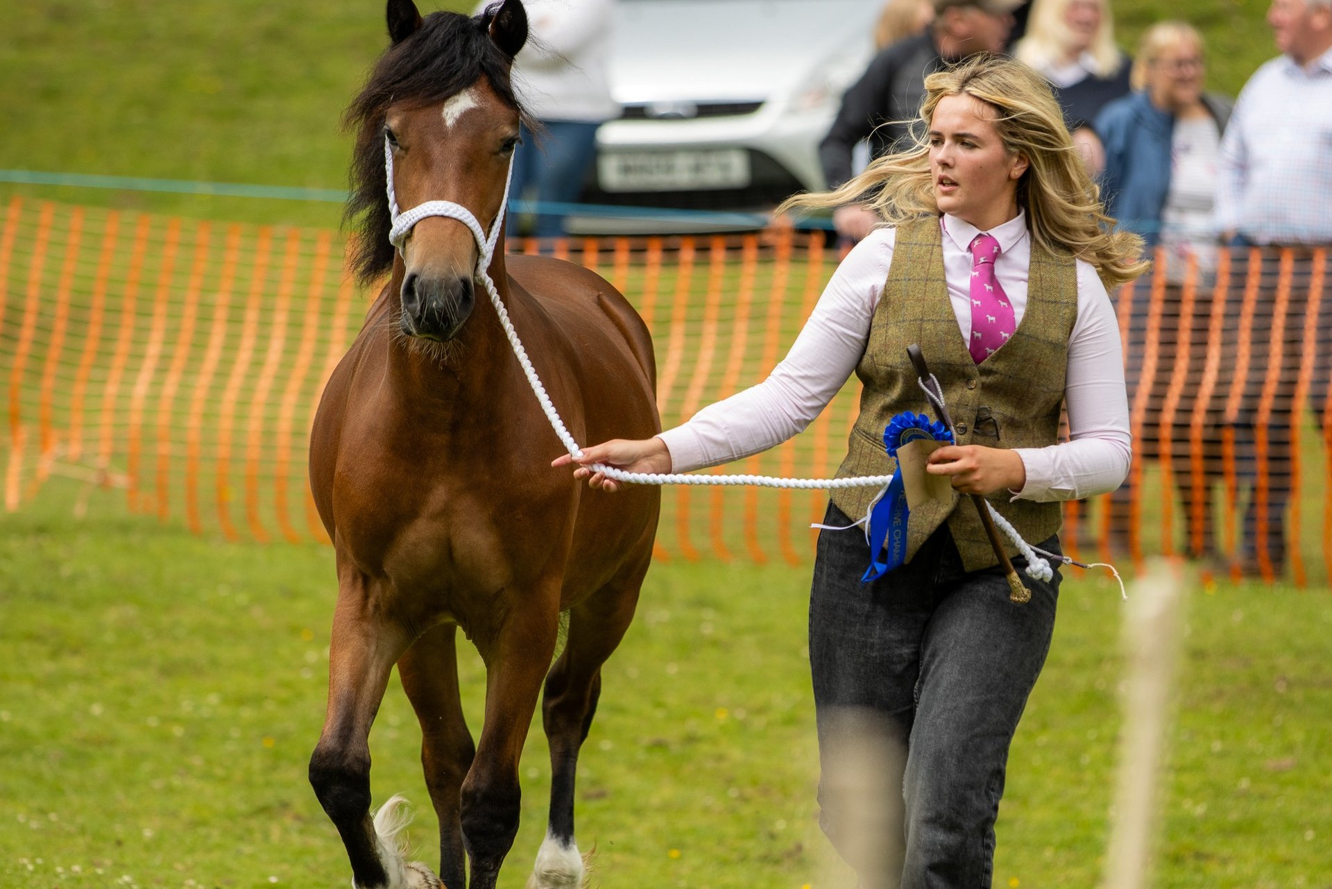 Girl running with a horse at an agricultural show