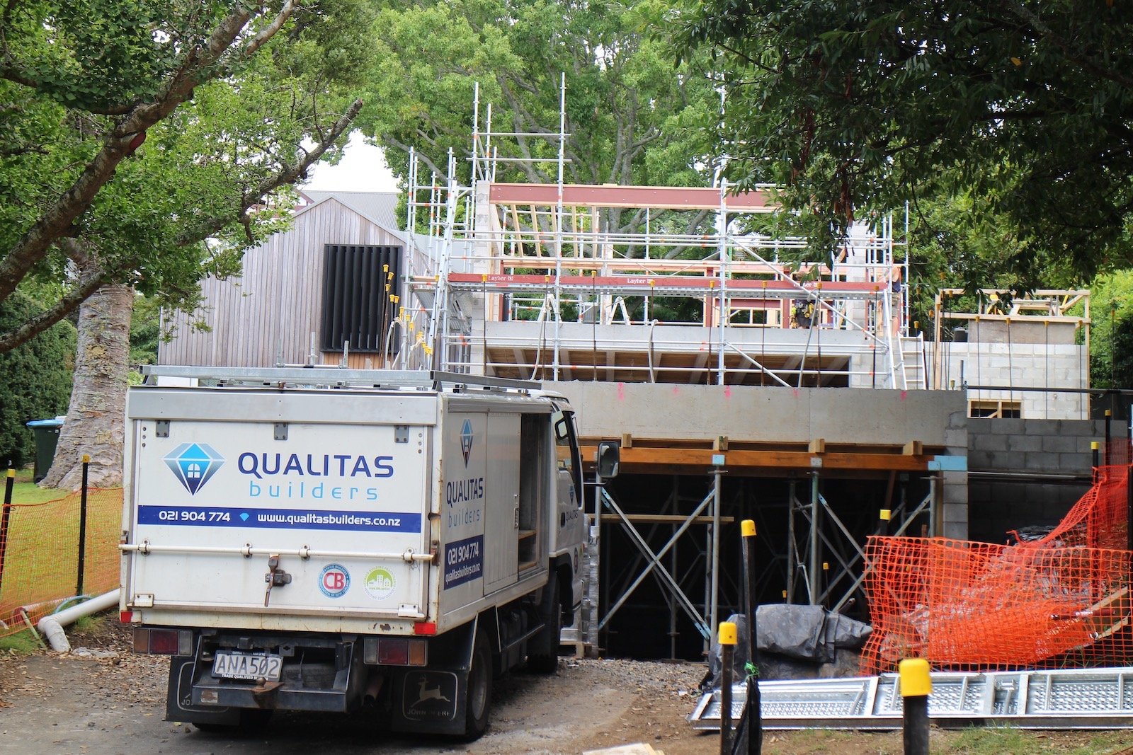 in-progress renovation project by Qualitas Builder, Auckland - truck with Qualitas Builders logo in front of scaffolding