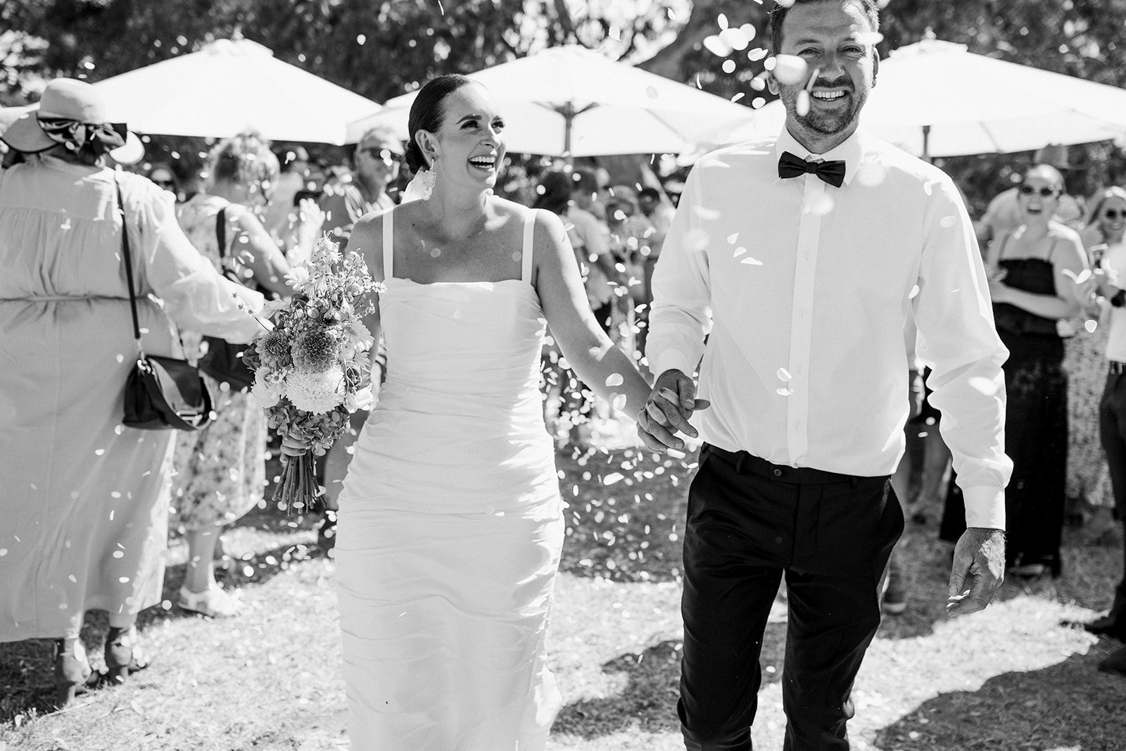 Newlyweds walk down the aisle at a Noosa beach wedding ceremony