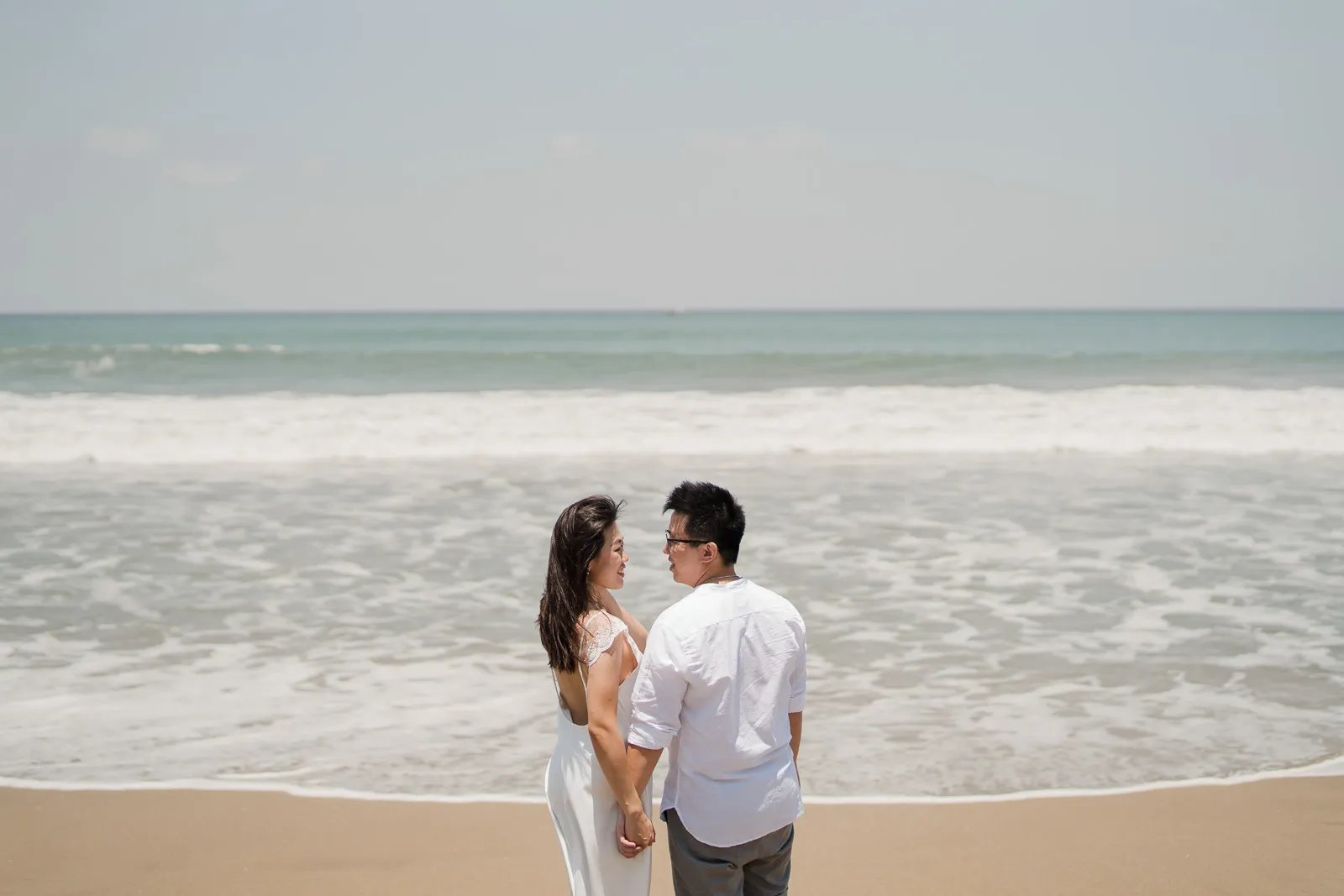 Couple sharing a quiet beach moment during a family session at W Bali Seminyak