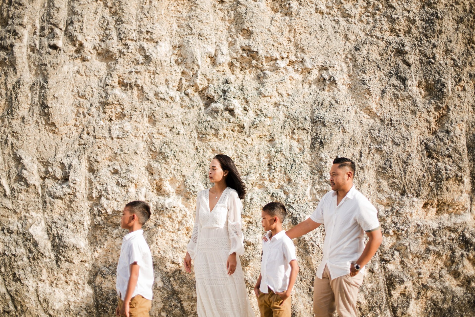 Ayunda family walking through the limestone cliffs road near Melasti Beach Bali.