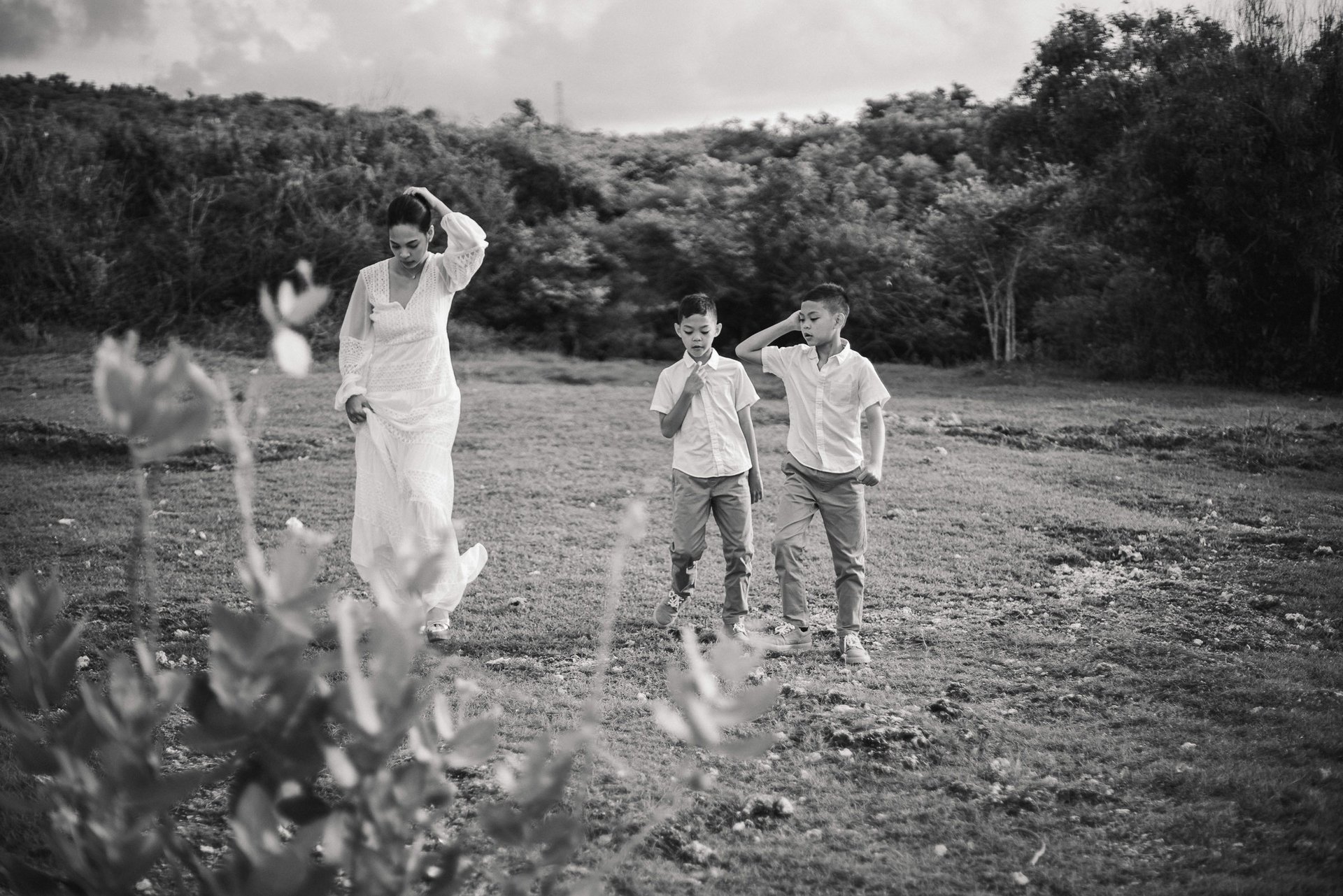 Ayunda family walking playfully together during golden hour at Melasti Beach Bali.