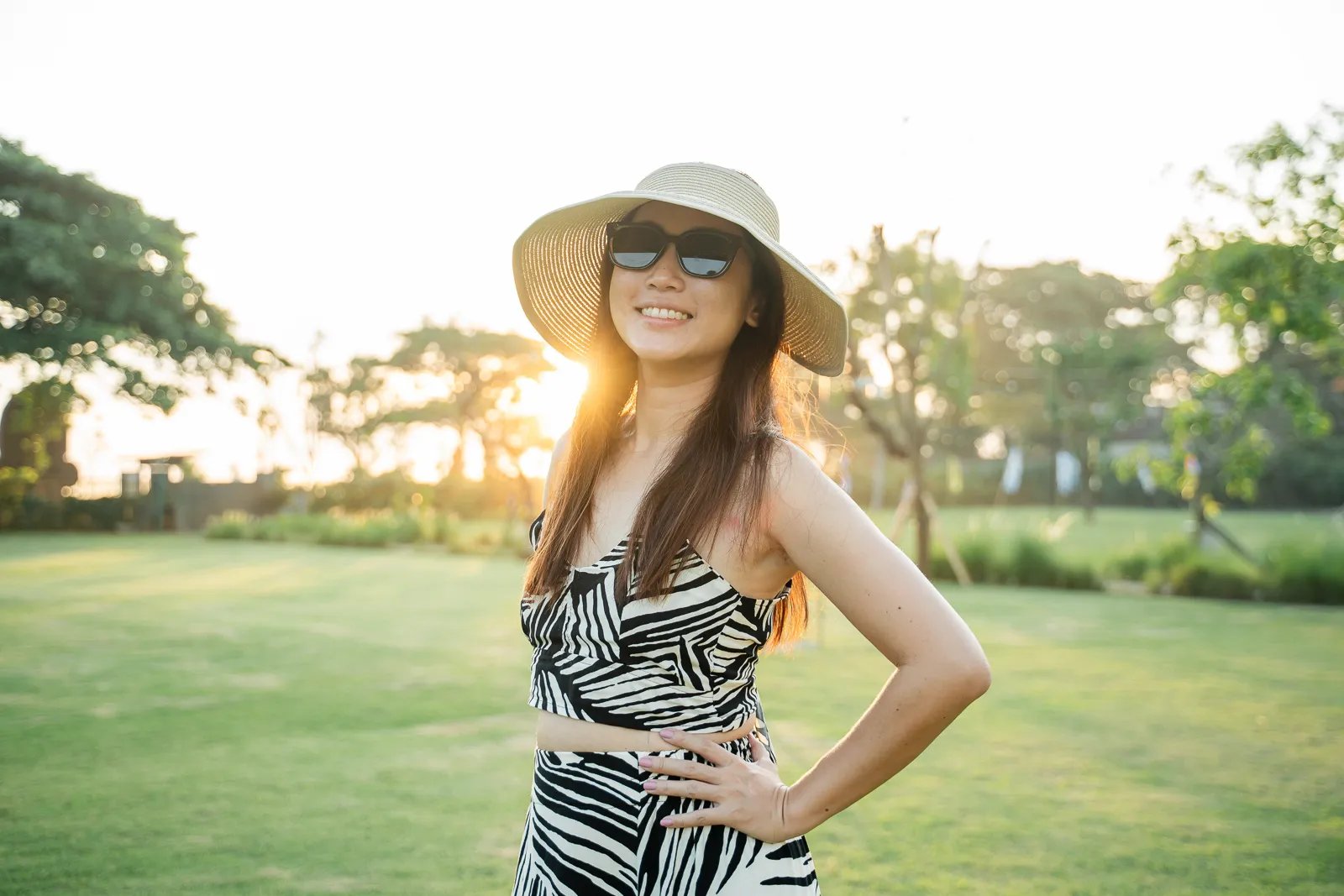 Lifestyle portrait of woman at Padma Resort Legian Bali with warm sunset light and tropical atmosphere.