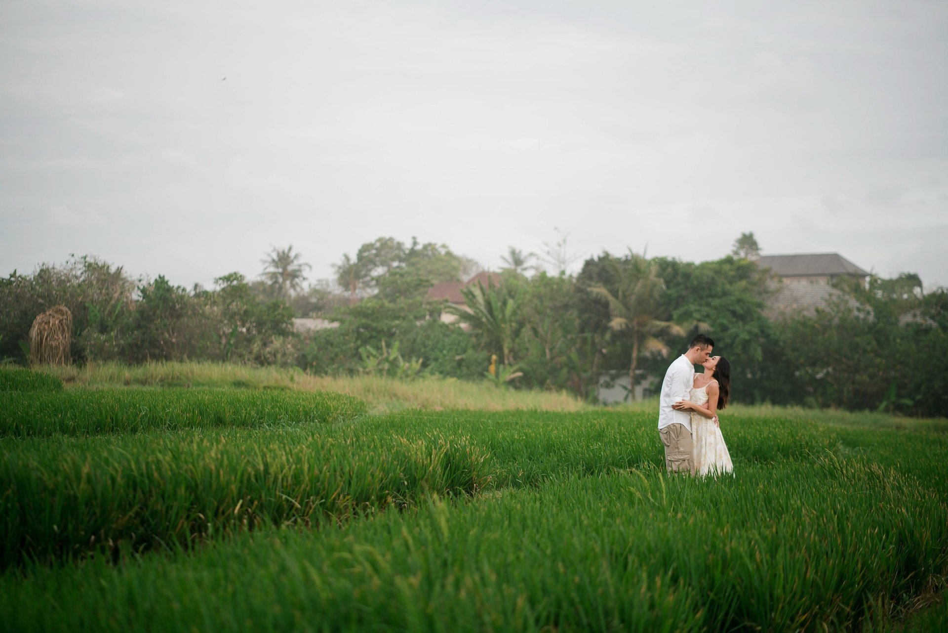 Intimate couple embracing in rice fields at Waka Gangga Tabanan West Bali during a natural session