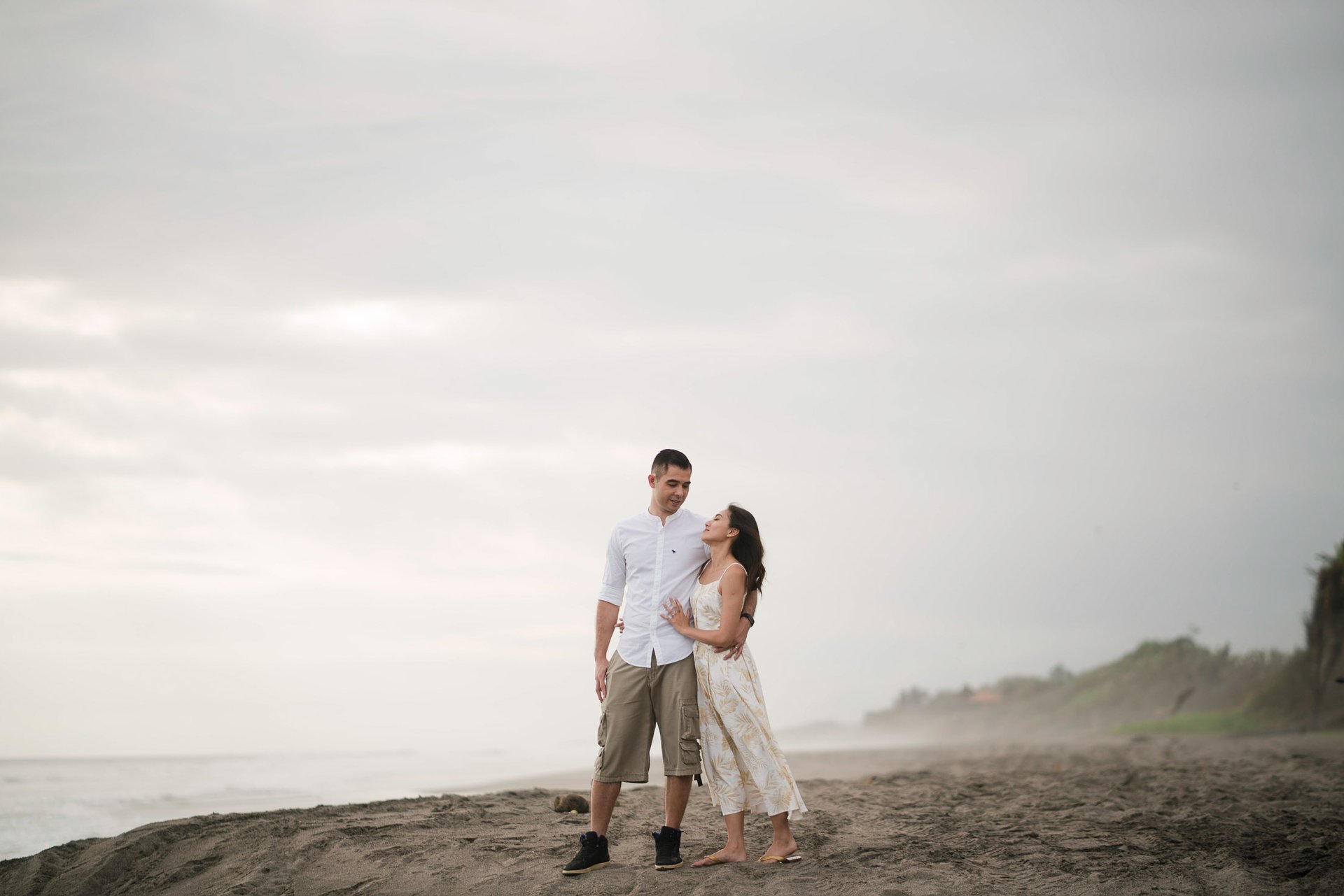 Couple walking along quiet beach at Waka Gangga Tabanan West Bali