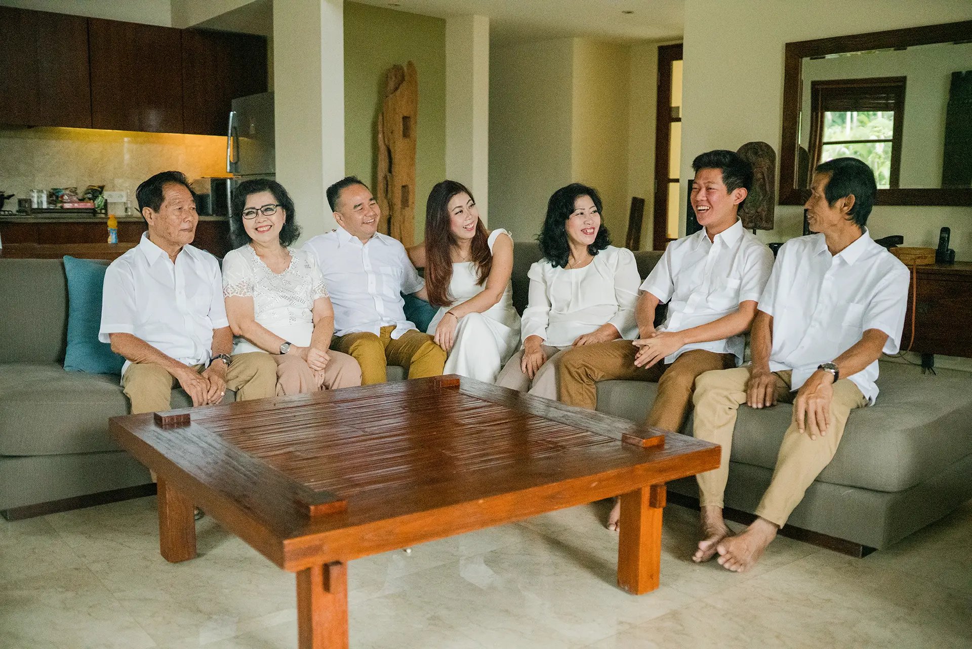Selly family gathering naturally inside a luxury villa living room during a family photography session at Karma Kandara 
