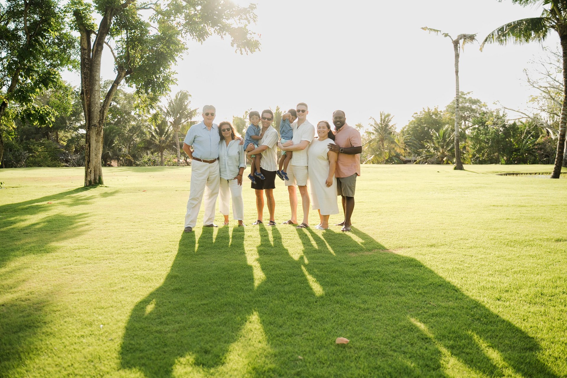 multi generation family walking together on the lawn at rimba by ayana bali during a relaxed bali family photography session