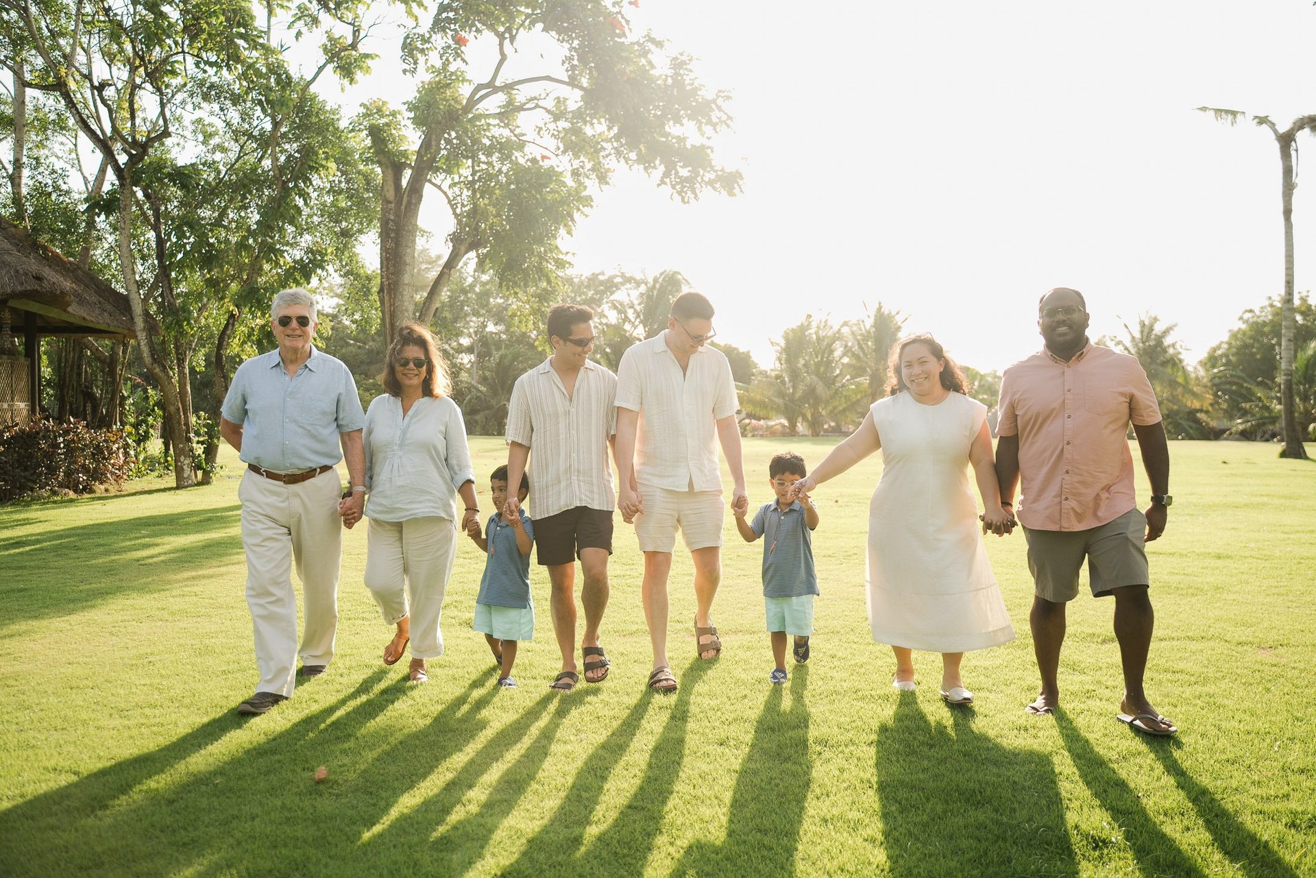 extended family walking together on the lawn at rimba by ayana bali during bali family photography