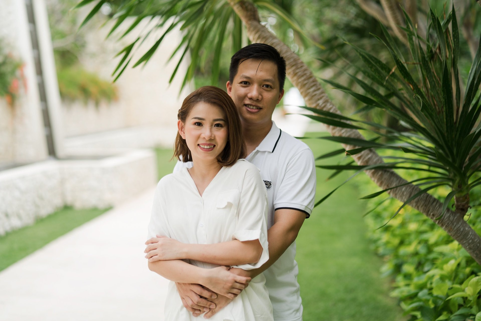 Couple portrait of Natalia's parents in tropical garden at The Mulia Nusa Dua Bali during a family photo session