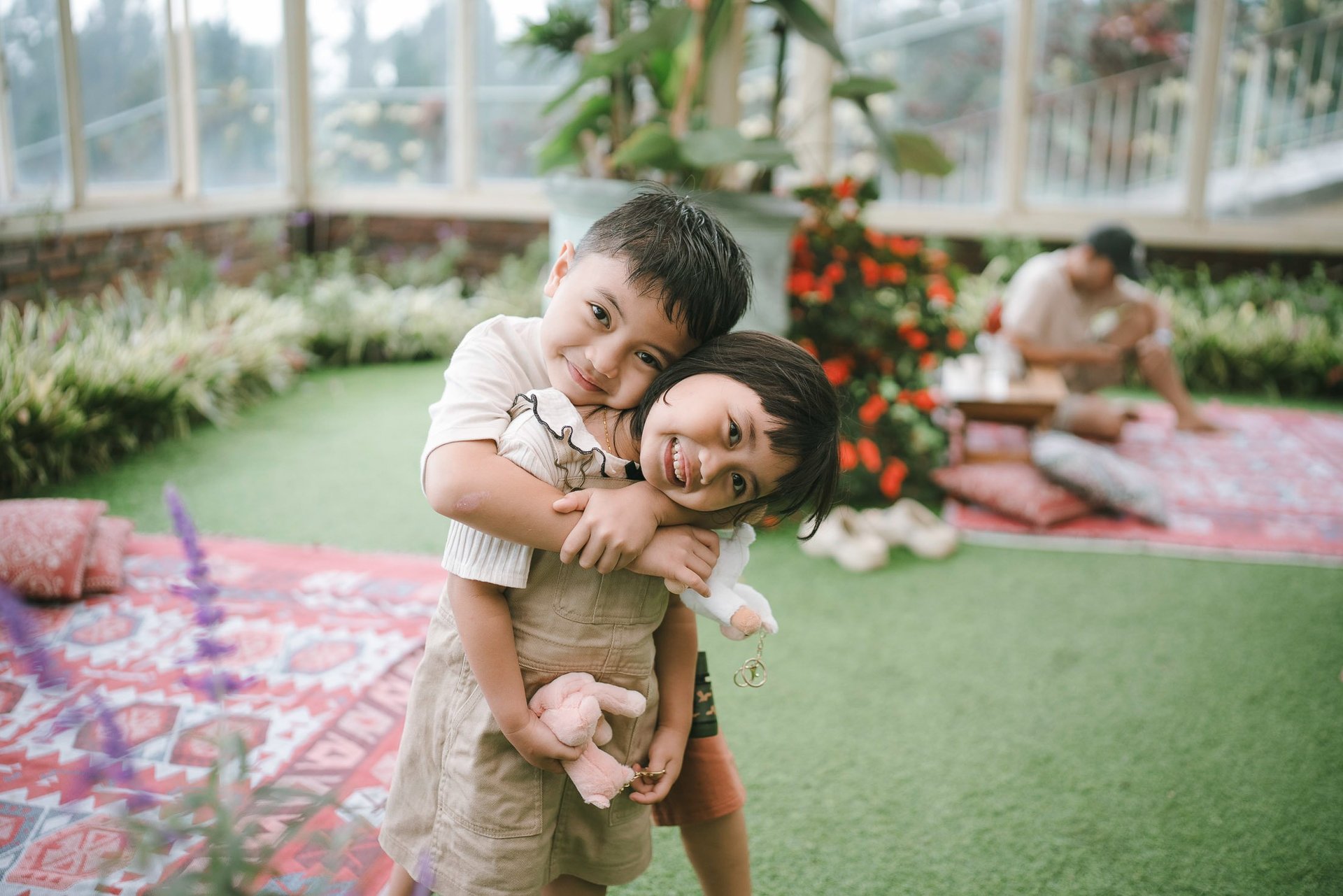 Family portrait inside glass house during a family photography session at Rumah Gemuk Bedugul Bali.