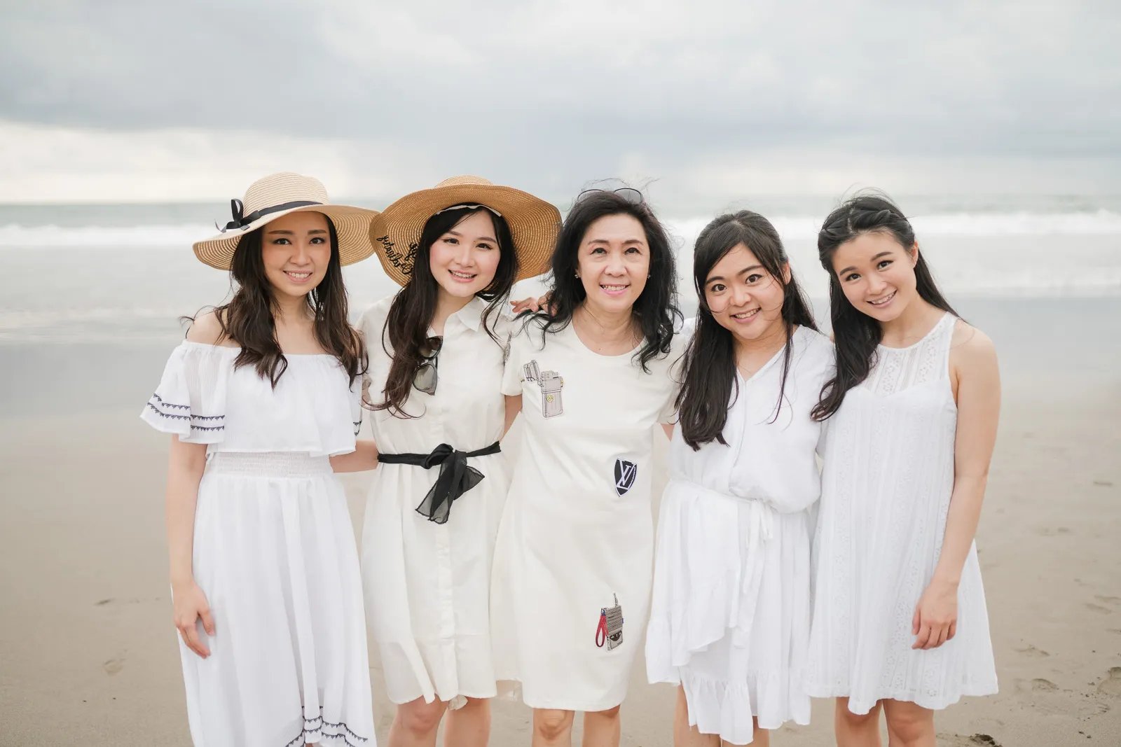Women from multigeneration family posing together at Alila Seminyak Bali during elegant family photography session.